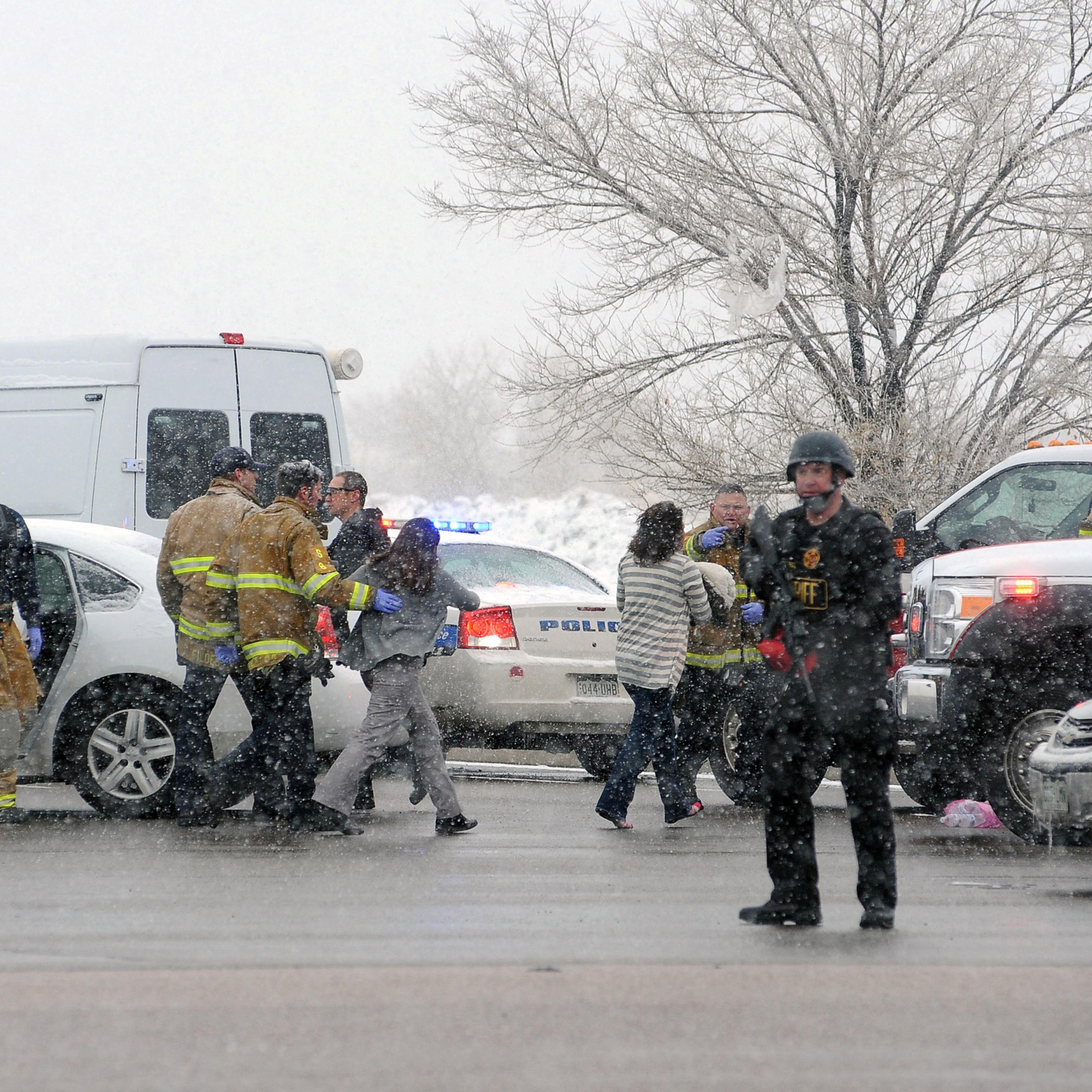 A woman is escorted by emergency personnel after reports of a shooting near the Planned Parenthood clinic Friday, Nov, 27, 2015, in Colorado Springs, Colo. According to authorities multiple injuries have been reported. (Daniel Owen/The Gazette via AP) MA