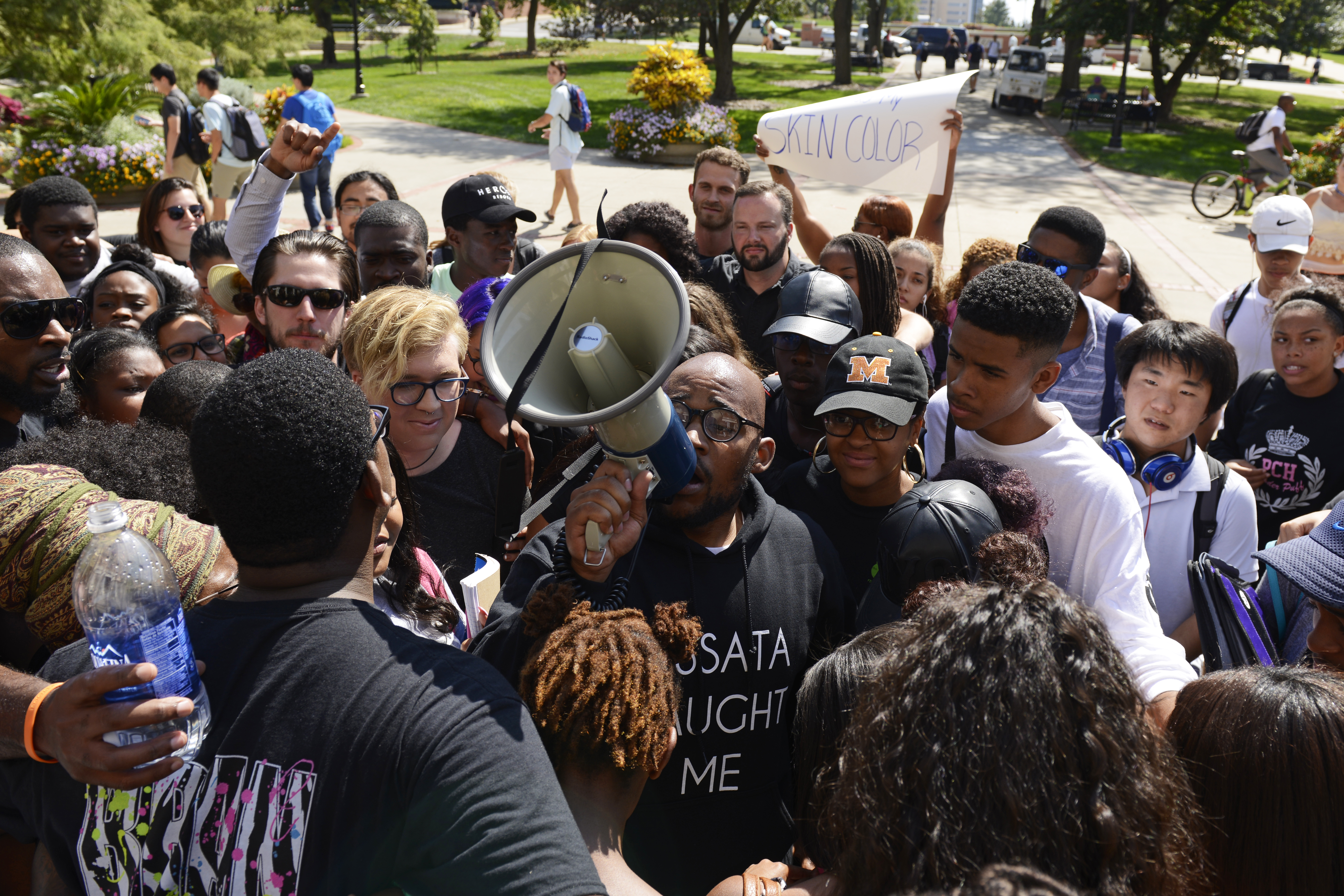 Students gather around graduate student Jonathan Butler for a group hug after marching into Jesse Hall on the University of Missouri campus in Columbia, Mo. on Sept. 24, 2015.