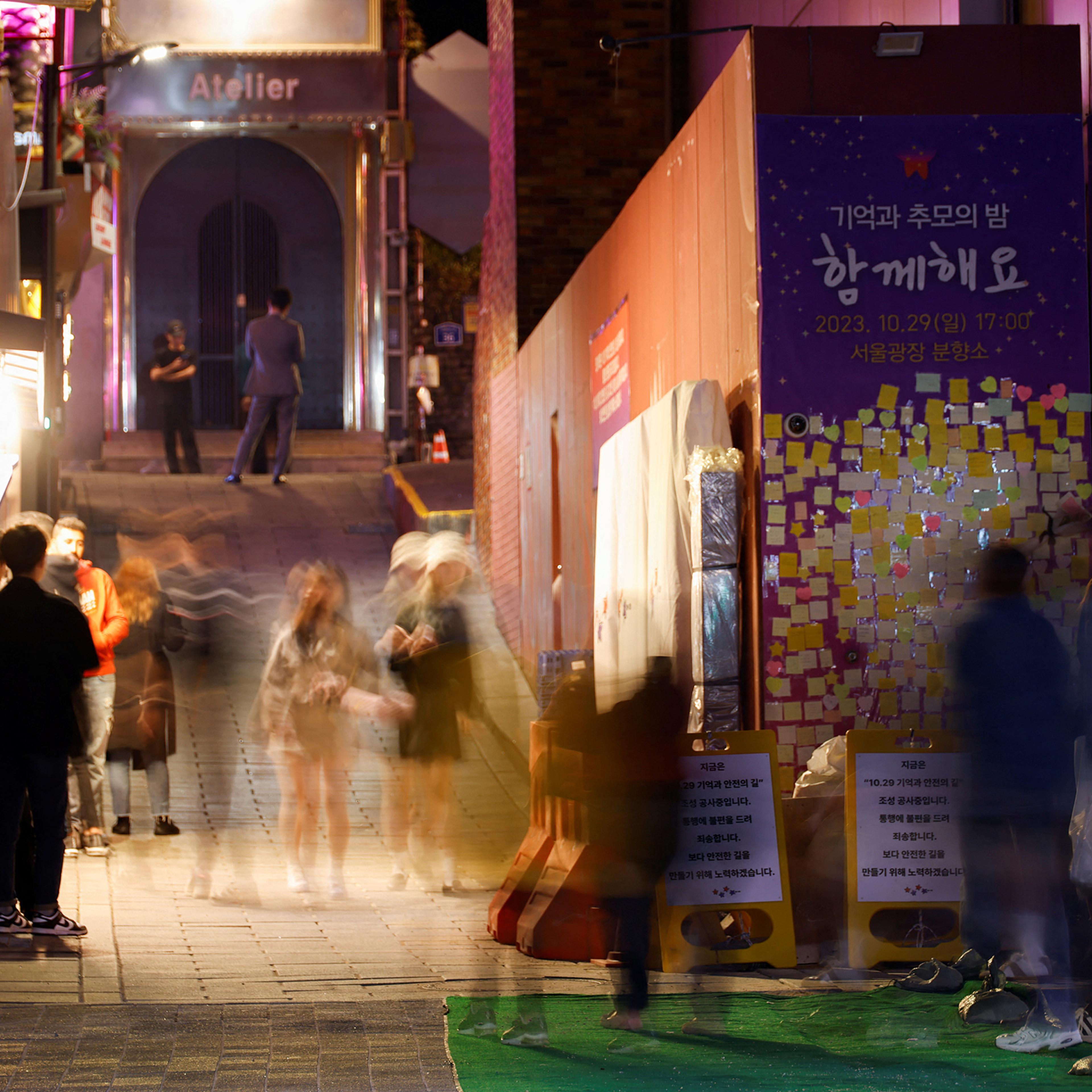 People walk through an alley in Itaewon where the Halloween crowd crush occurred last year, in Seoul, South Korea, on Oct. 23.