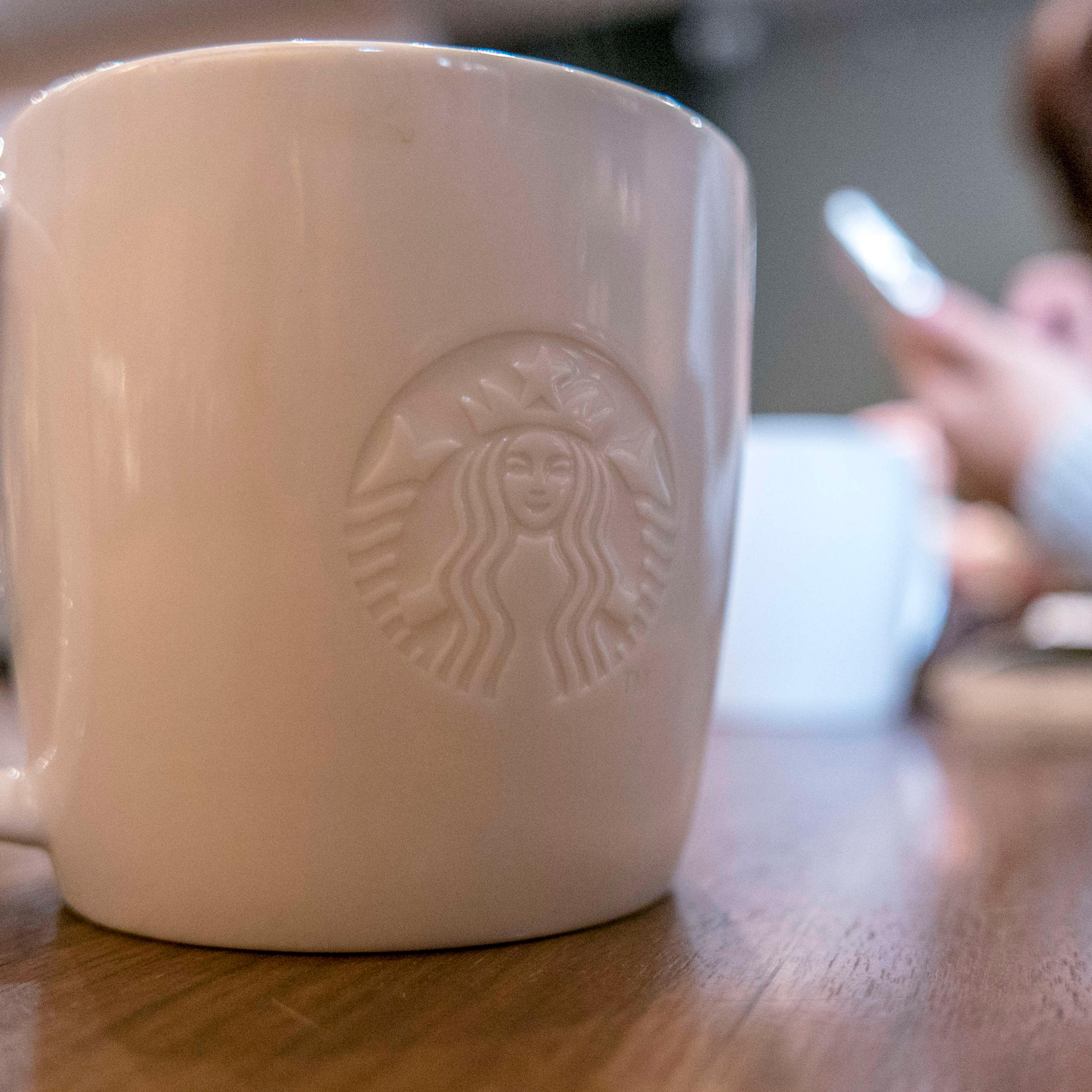 Logo of Starbucks on a coffee mug.