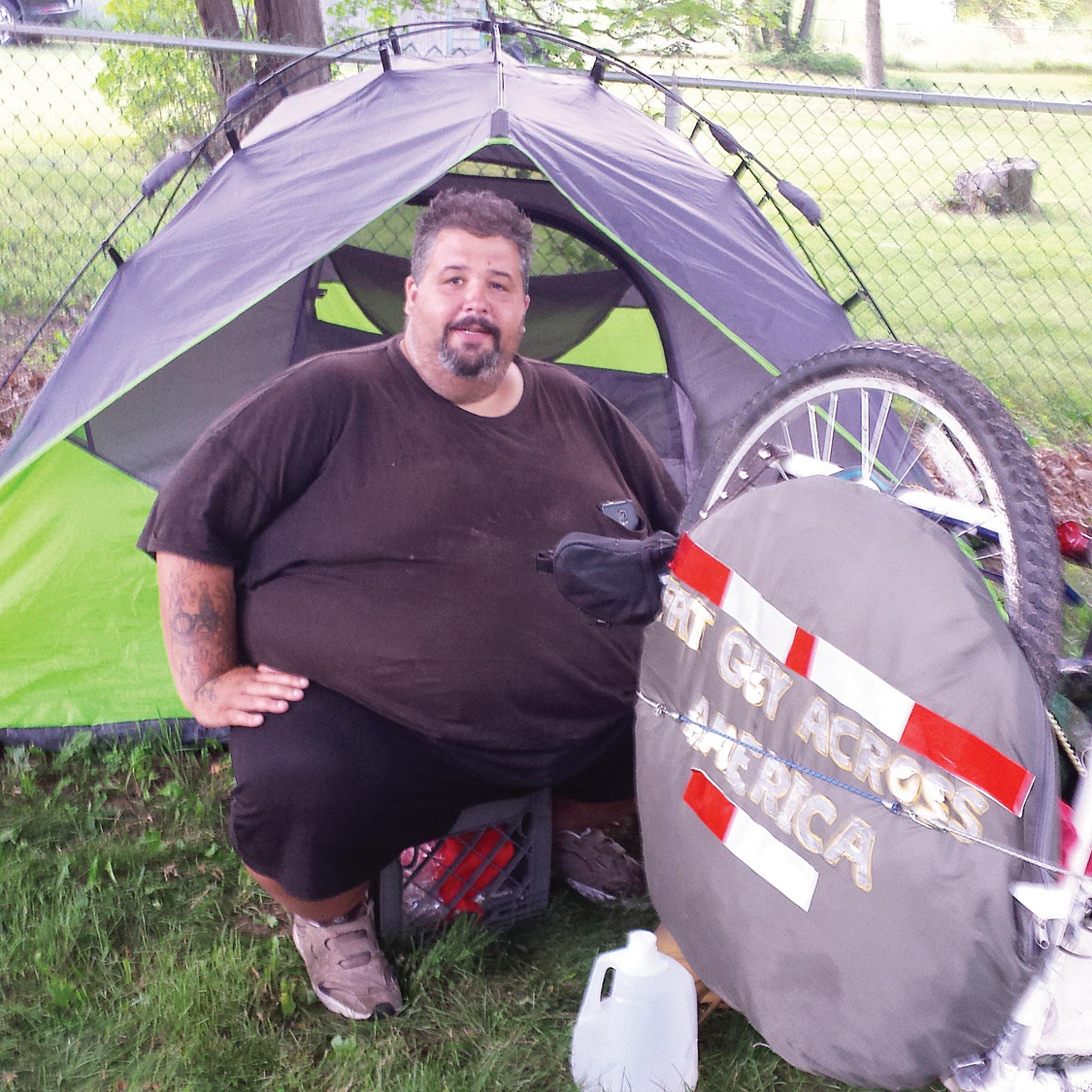 Eric Hites, rests at the Bliss Congregational Church in Tiverton, R.I on July 21, 2015, while he waits for a new bicycle so he can continue his cross-country ride. The about 560-pound man is biking across the United States to lose weight.