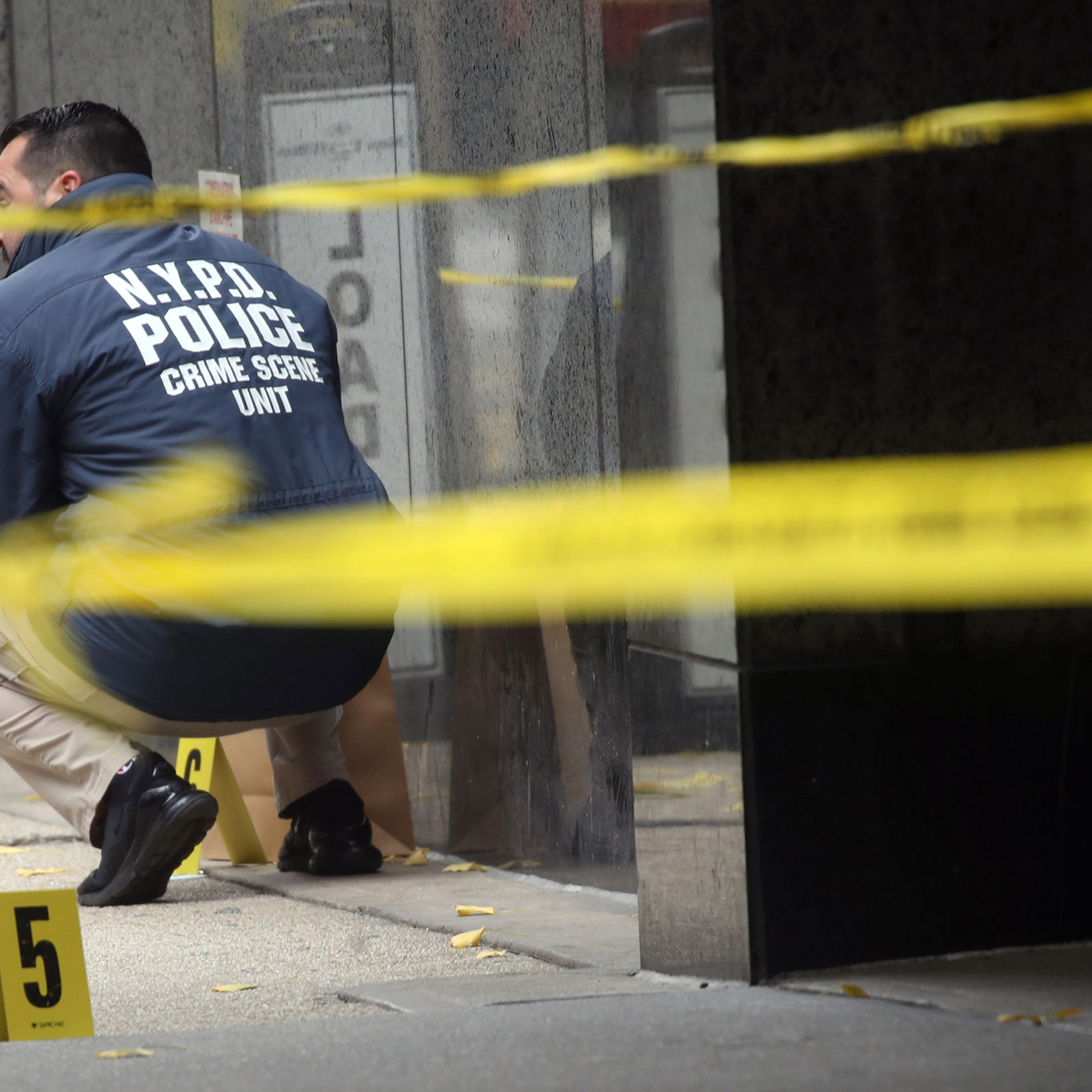 Police place bullet casing markers outside of a Hilton Hotel in Midtown Manhattan where United Healthcare CEO Brian Thompson was fatally shot on Dec. 4, 2024.