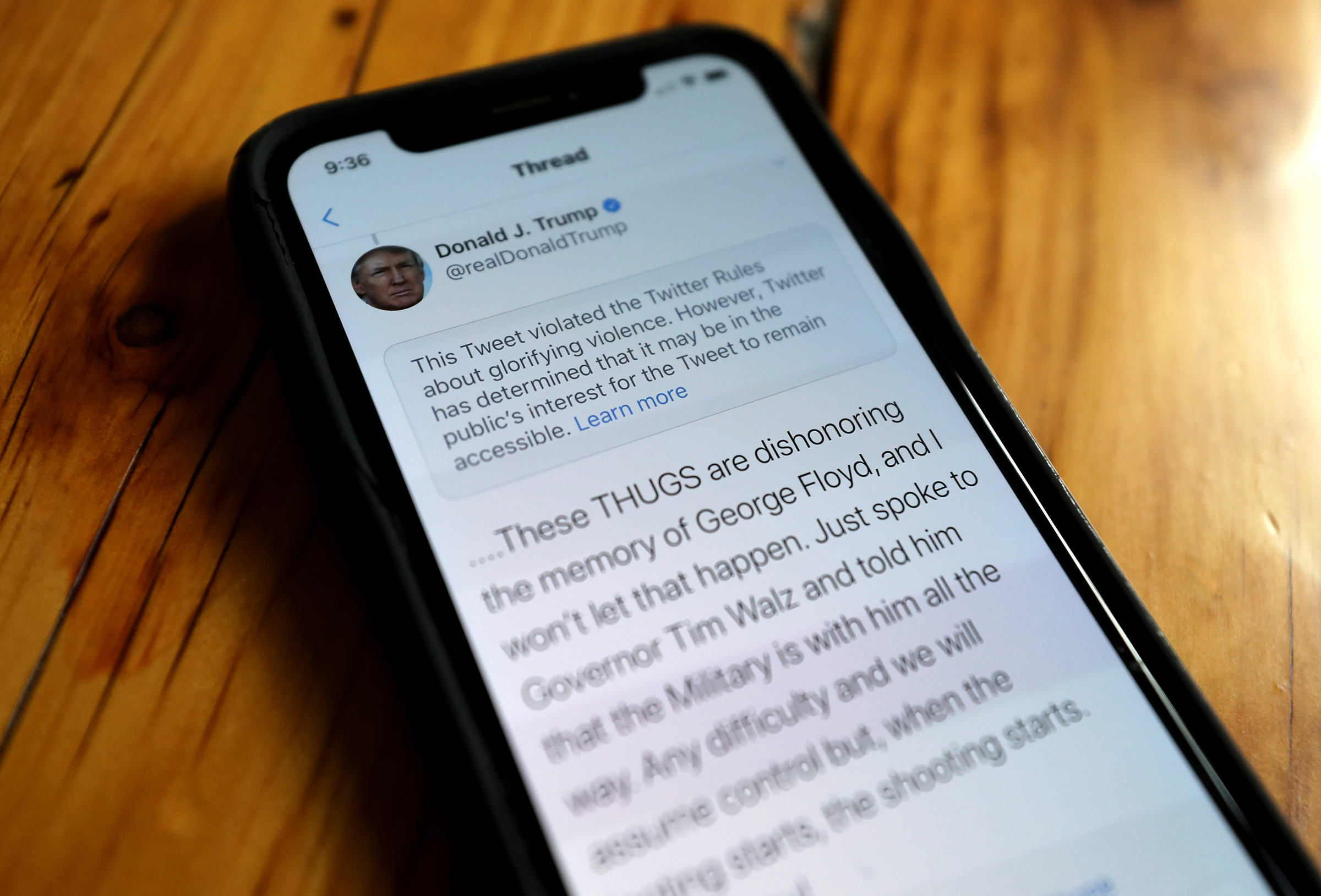 A notification from Twitter appears on a tweet by President Trump warning that it violated its policy on May 29
