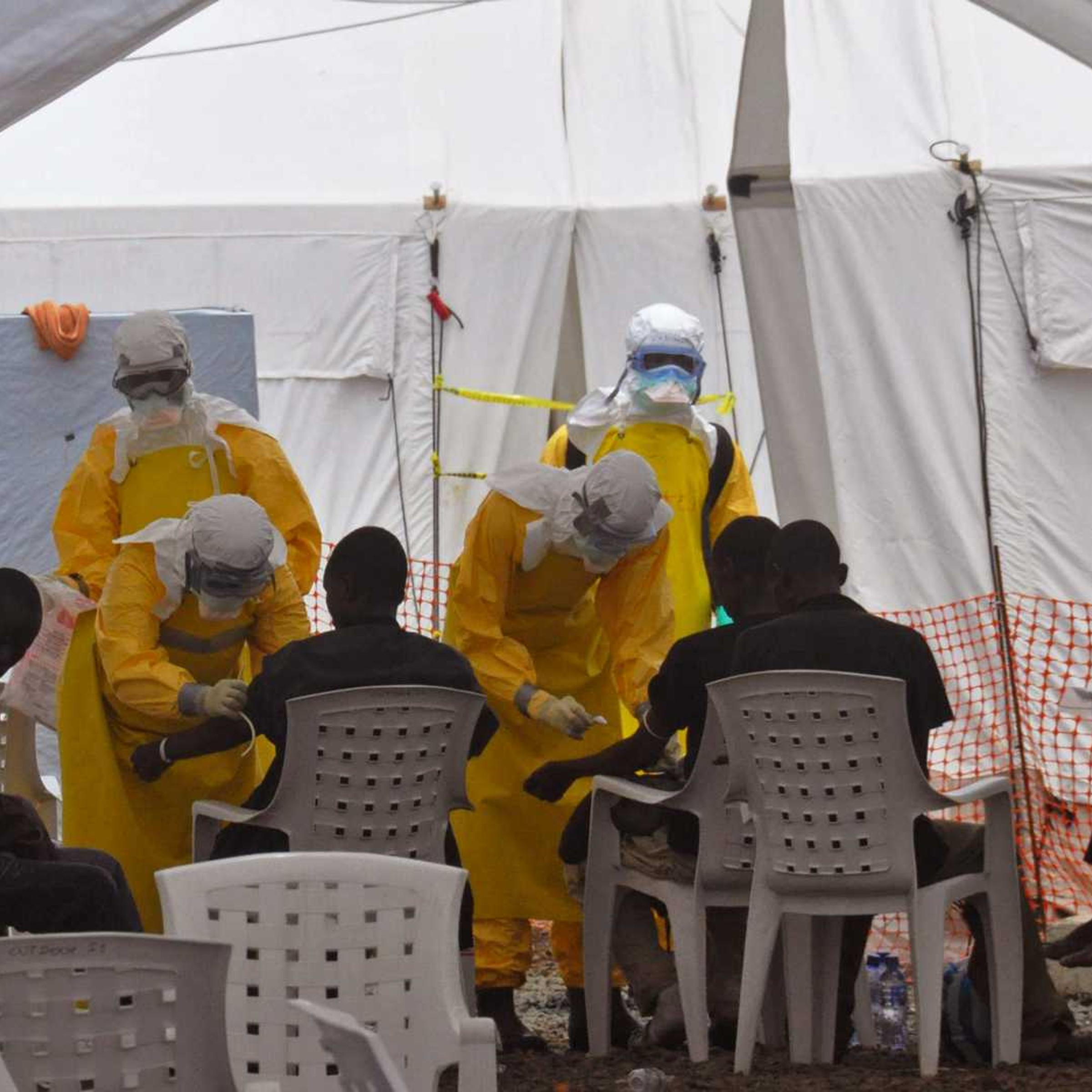 Health workers, attend to patients that contracted the Ebola virus, at a clinic in Monrovia, Liberia, Monday, Sept. 8, 2014.