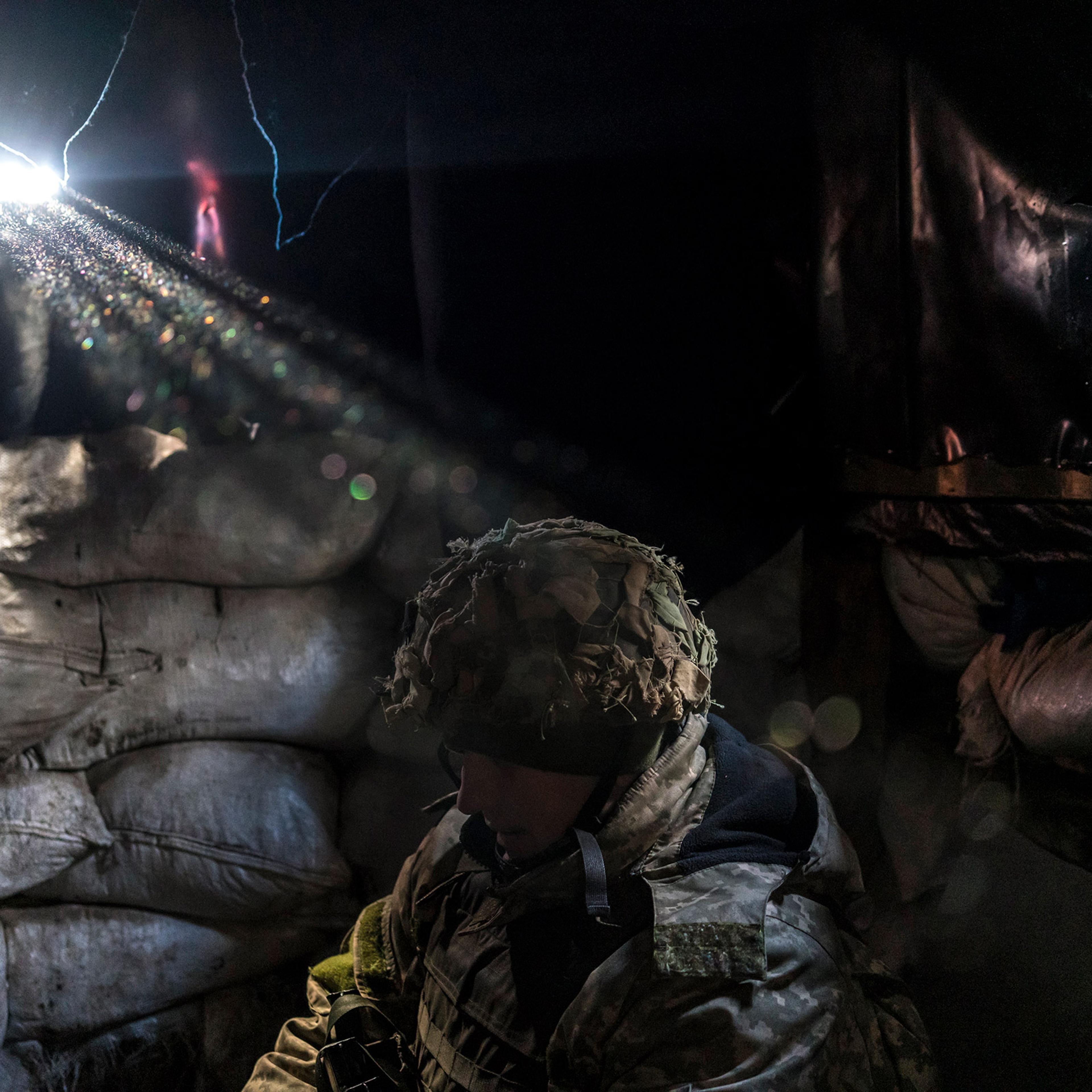 A member of the Ukrainian army's 25th Airborne Brigade at a front-line position in the industrial zone in Avdiivka, Ukraine, Dec. 2, 2021. (Brendan Hoffman/The New York Times)