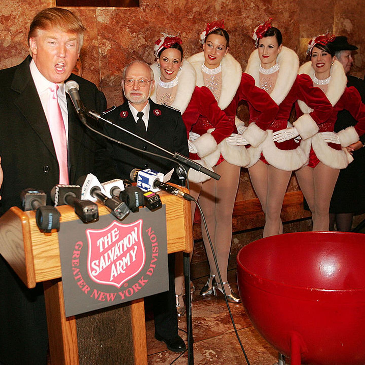 The Radio City Rockettes listen as Donald Trump speaks during a ceremony to help The Salvation Army kick off its annual Christmas kettle effort at the Trump Tower Atrium on Nov. 23, 2004 in New York City.