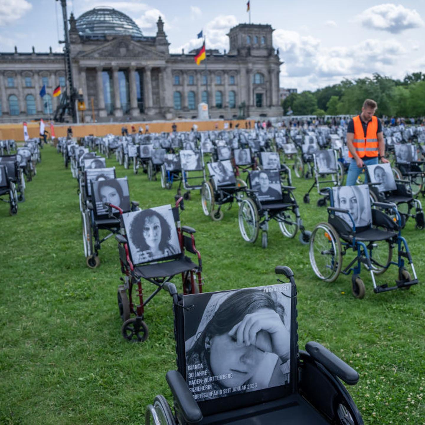 Wheelchairs are posed in front of the German Reichstag building in Berlin to protest a lack of progress on Long COVID.