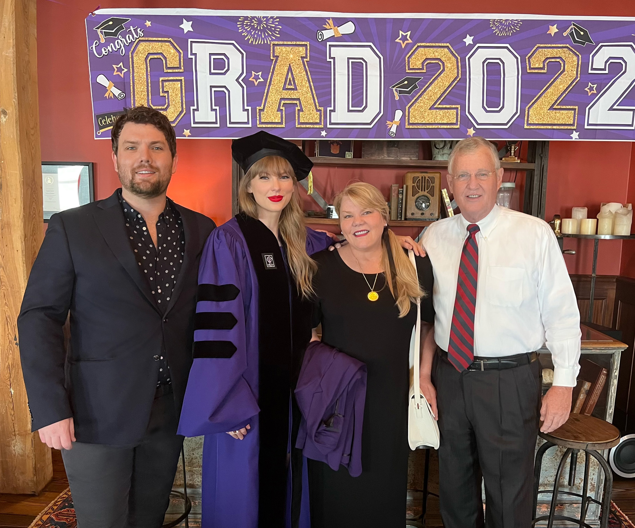 Austin, Andrea, and Scott Swift with Taylor at NYU graduation in 2022 where she received an honorary Doctorate of Fine Arts