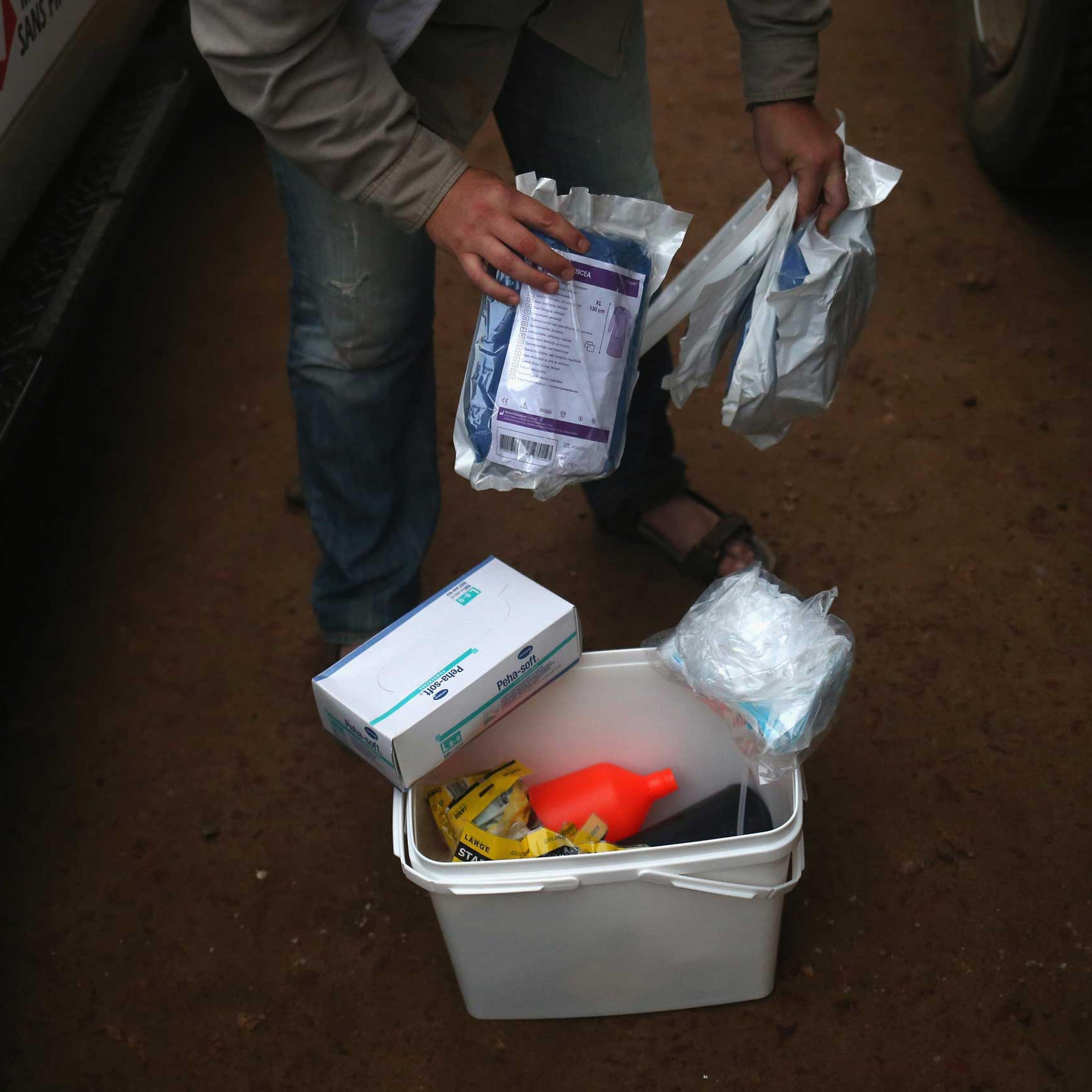 A Doctors Without Borders, worker displays a family and home disinfection kit which MSF distributed on Oct. 4, 2014 in New Kru Town, Liberia.