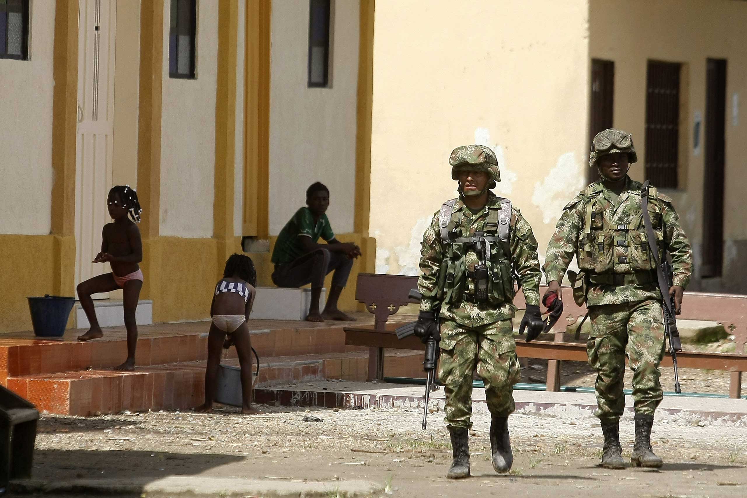 Members of the Colombian Army patrol the sites of Las Mercedes towship, Choco Department, west of Colombia, on Nov. 18, 2014.