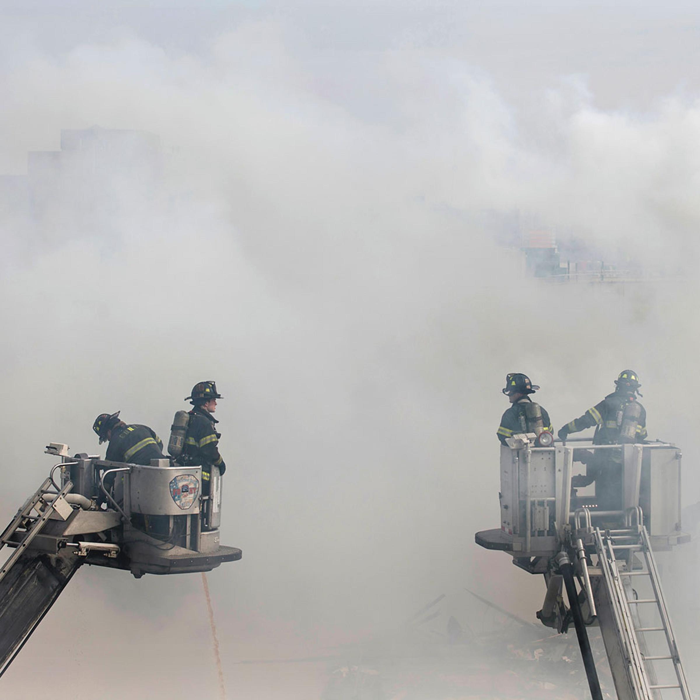 Firefighters respond to an explosion that leveled two apartment buildings in the East Harlem neighborhood of New York, March 12, 2014.