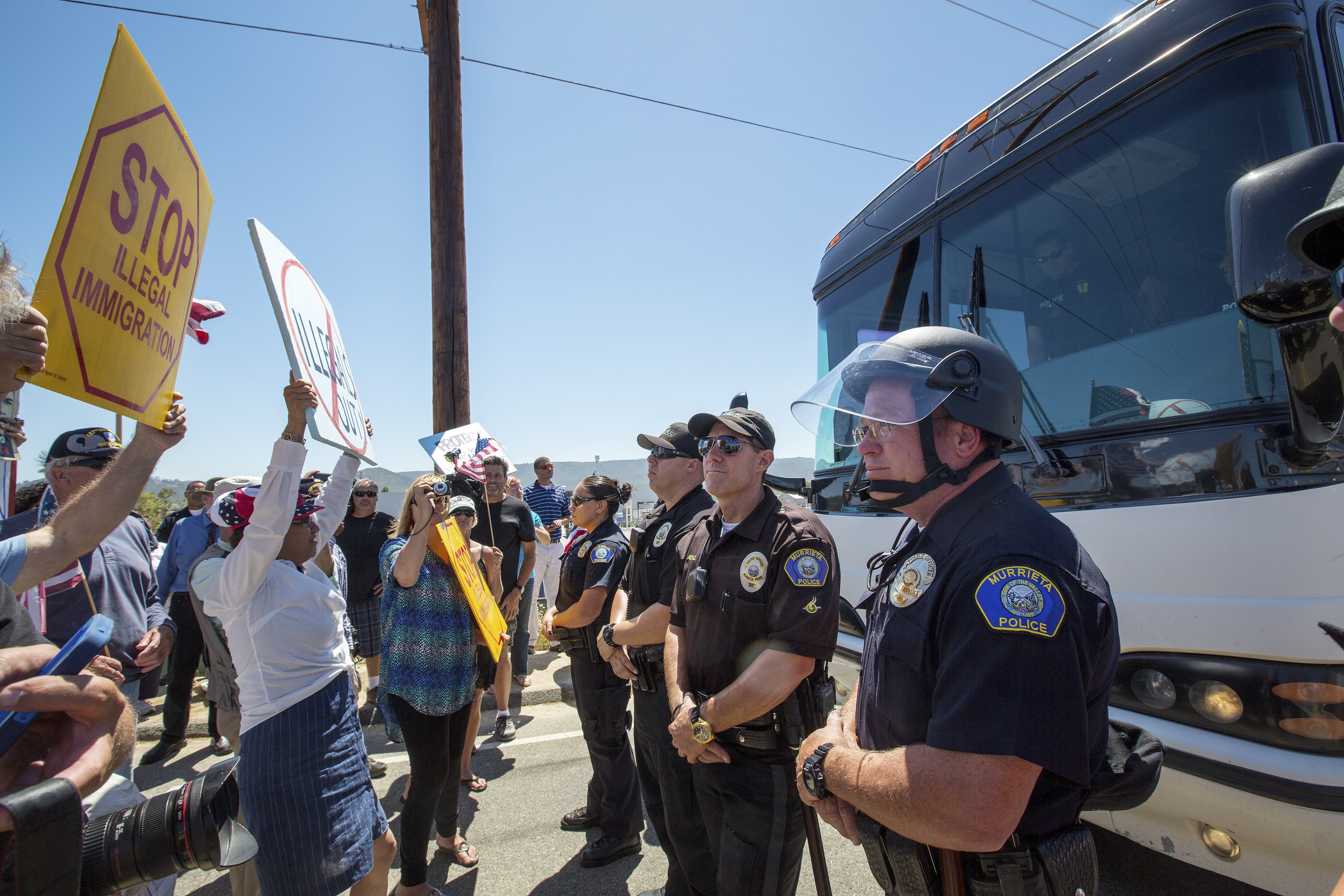 Anti-immigration protesters gather in front of a Border Patrol station in Murrieta, Calif. to block a bus of migrants transferred from overcrowded facilities in Texas.