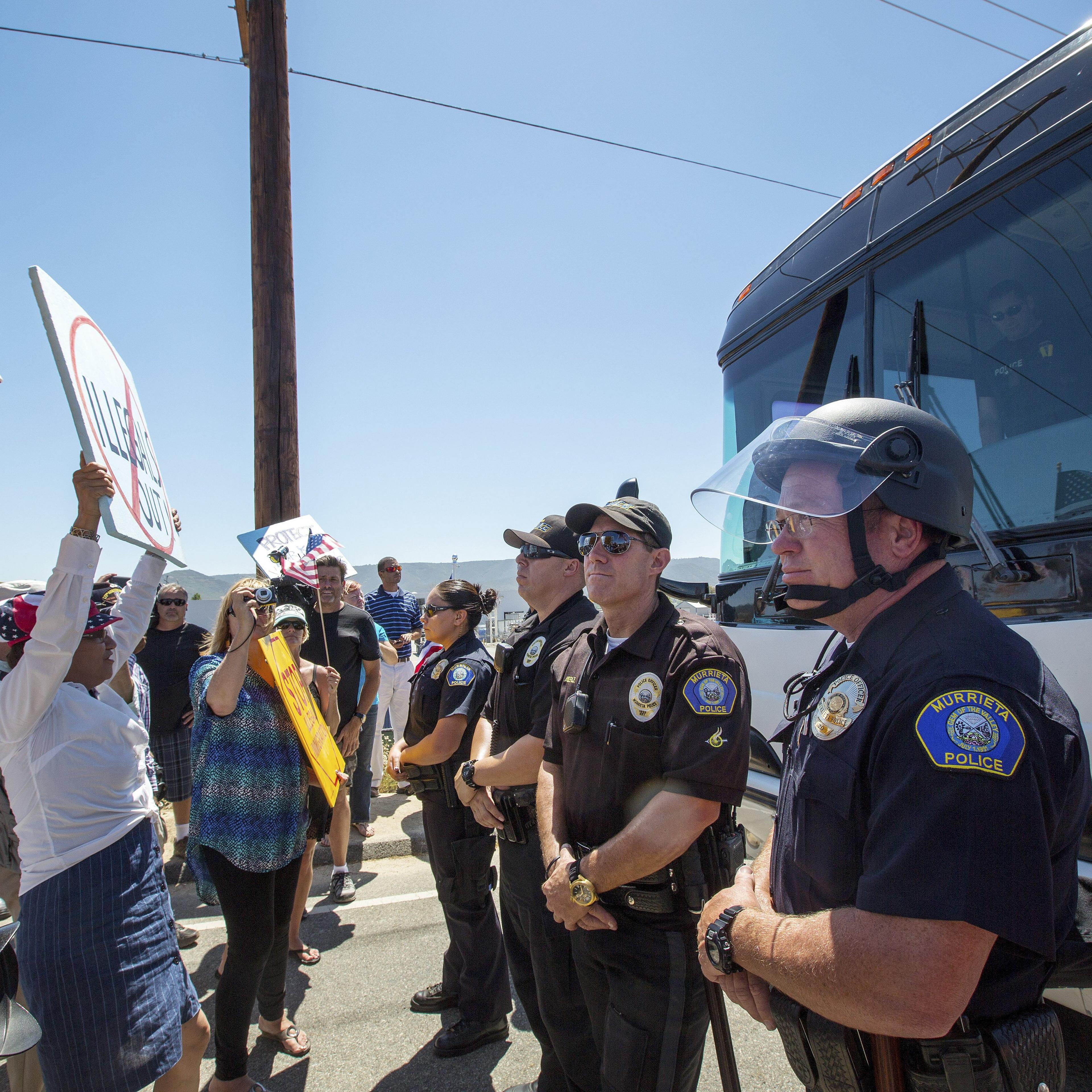 Anti-immigration protesters gather in front of a Border Patrol station in Murrieta, Calif. to block a bus of migrants transferred from overcrowded facilities in Texas.