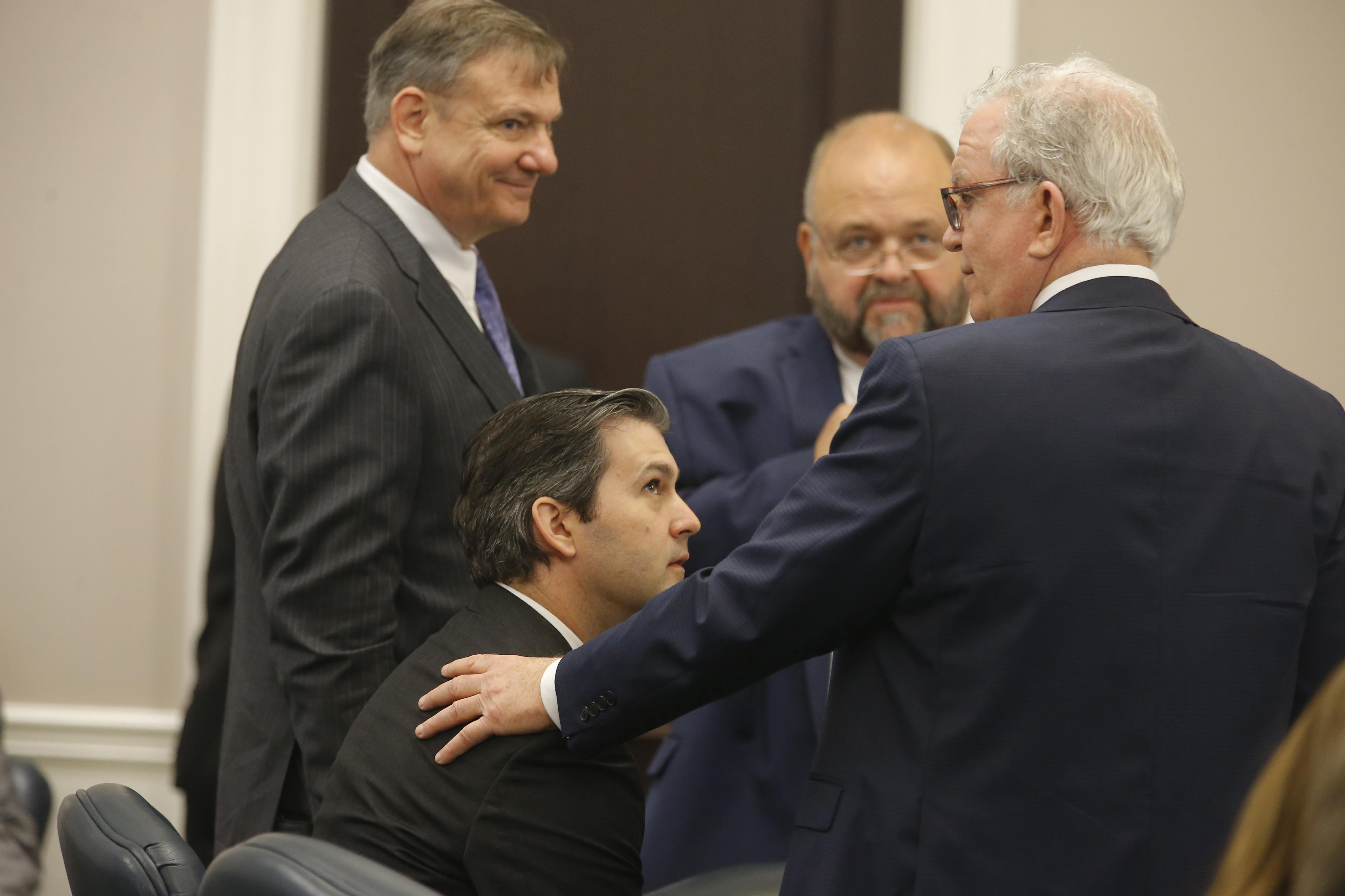 Defense attorneys Don McCune, left, Andy Savage and Miller Shealy surround former North Charleston police officer Michael Slager at the Charleston County court in Charleston, South Carolina, Dec. 5, 2016.