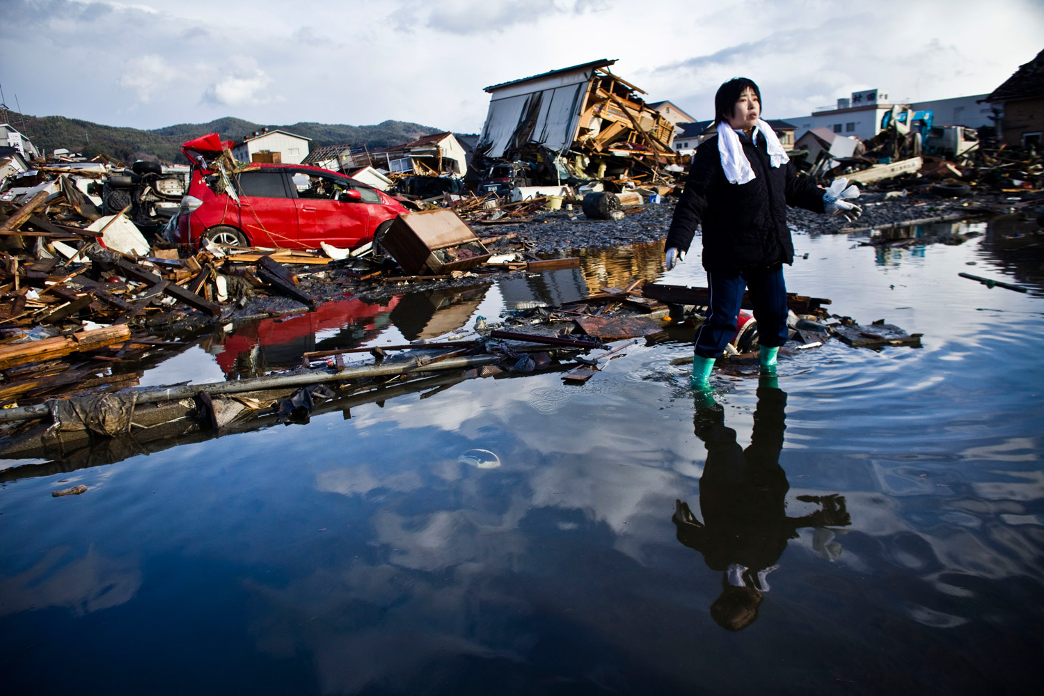 Chieko Chiba looks for the remains of her house in Kesennuma, Miyagi prefecture. "Everything is gone," she said.