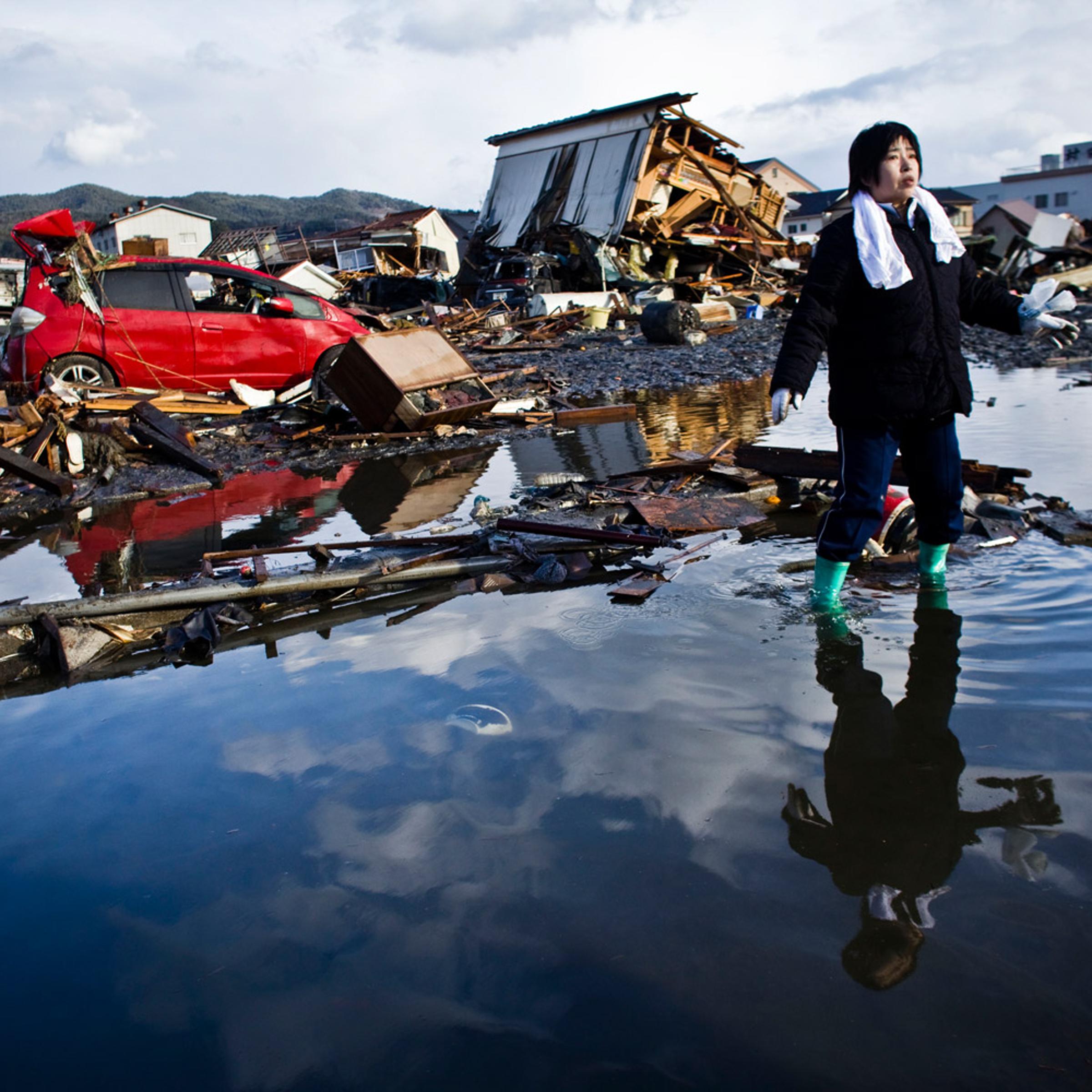 Chieko Chiba looks for the remains of her house in Kesennuma, Miyagi prefecture. "Everything is gone," she said.