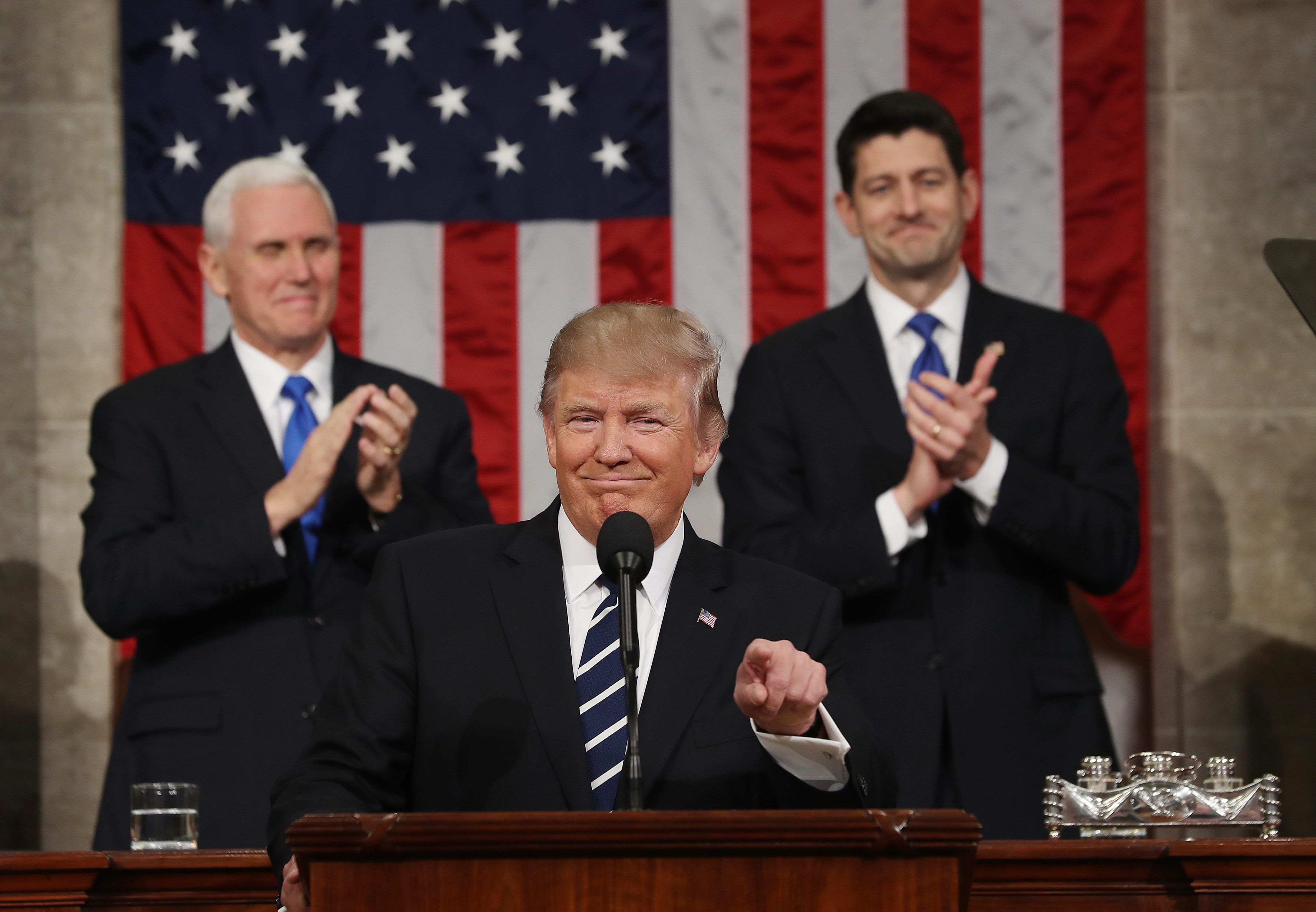 Vice President Mike Pence and Speaker of the House Paul Ryan applaud as President Donald J. Trump arrives to deliver his first address to a joint session of Congress in Washington on Feb. 28, 2017.