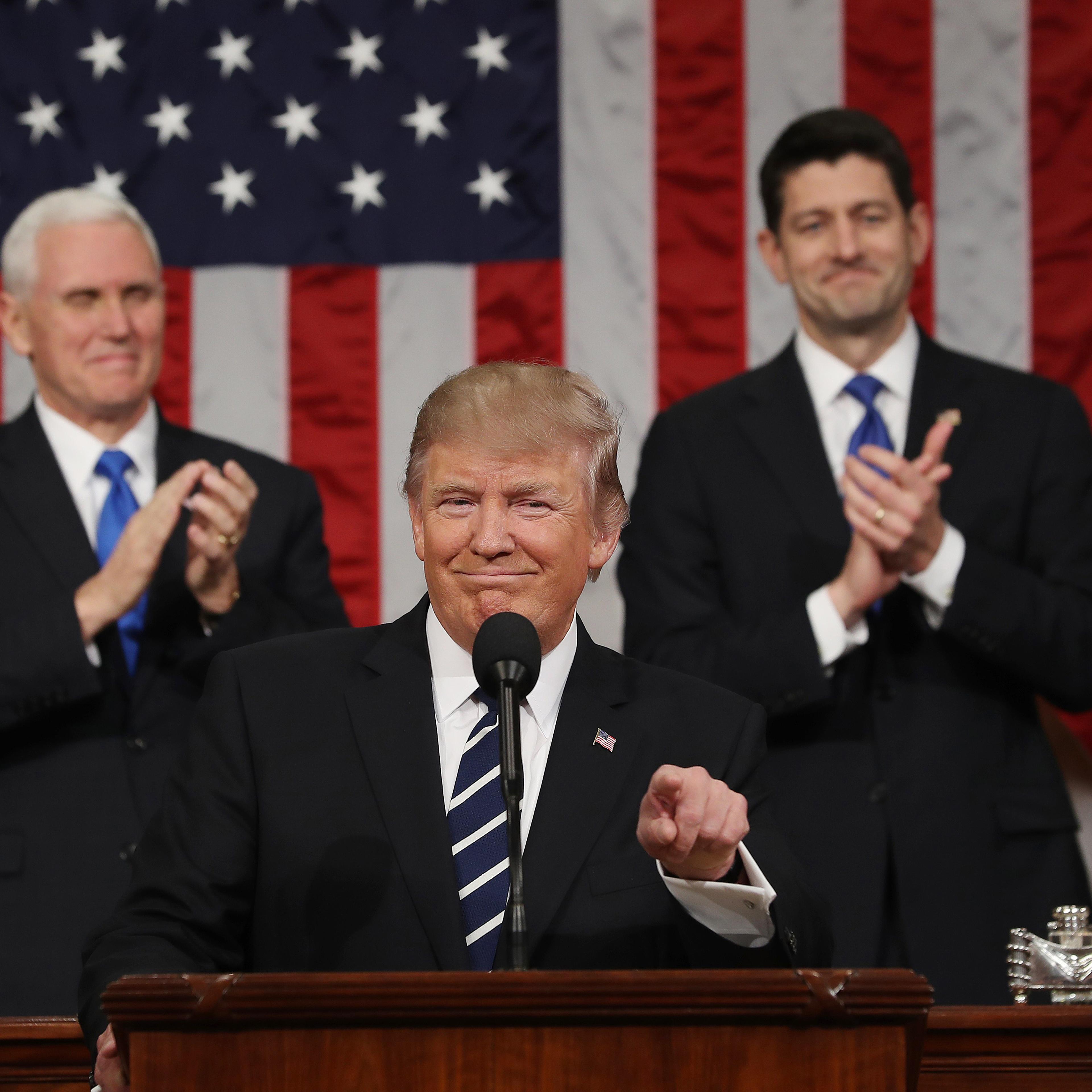 Vice President Mike Pence and Speaker of the House Paul Ryan applaud as President Donald J. Trump arrives to deliver his first address to a joint session of Congress in Washington on Feb. 28, 2017.