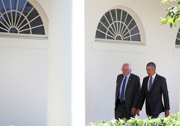 Democratic presidential candidate Sen. Bernie Sanders (D-VT) (L) walks with President Barack Obama (R) through the Colonnade as he arrives at the White House for an Oval Office meeting June 9, 2016 in Washington, DC.