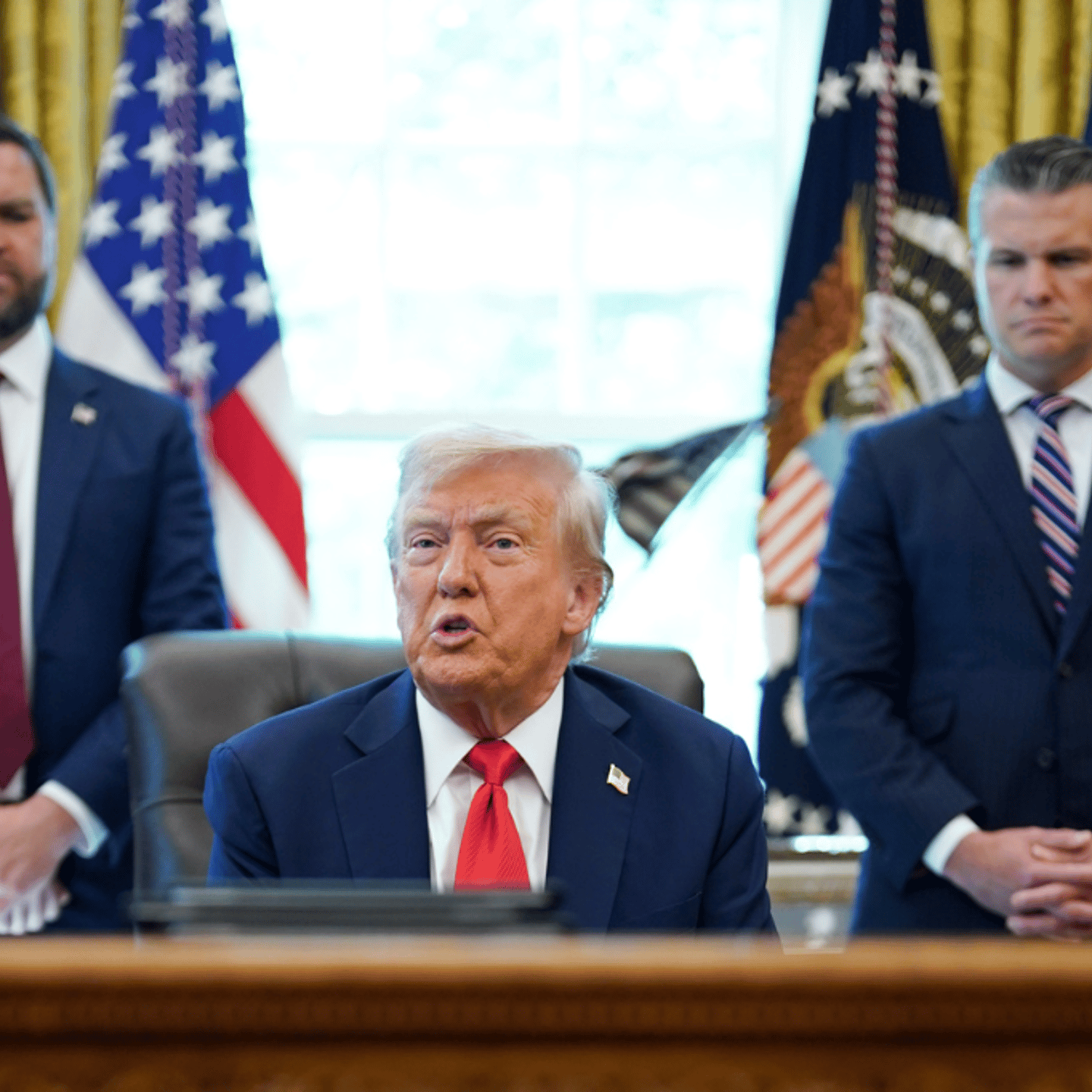 U.S. Vice President JD Vance, from left, President Donald Trump, and Pete Hegseth, U.S. Defense Secretary, during an executive order signing in the Oval Office of the White House in Washington, D.C., on Aug. 25, 2025.
