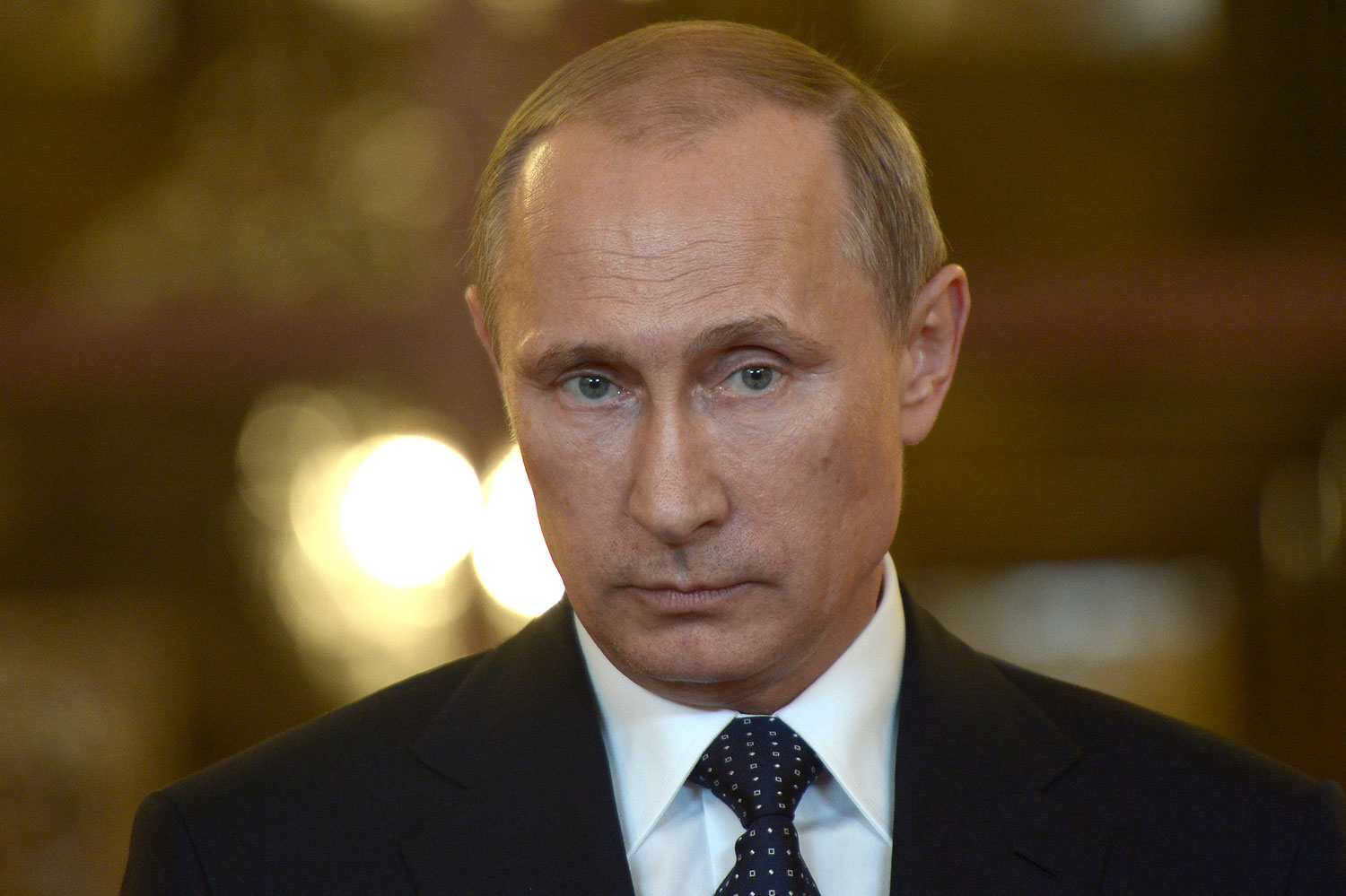 Russia's President Vladimir Putin talks to reporters during a meeting in Brasilia