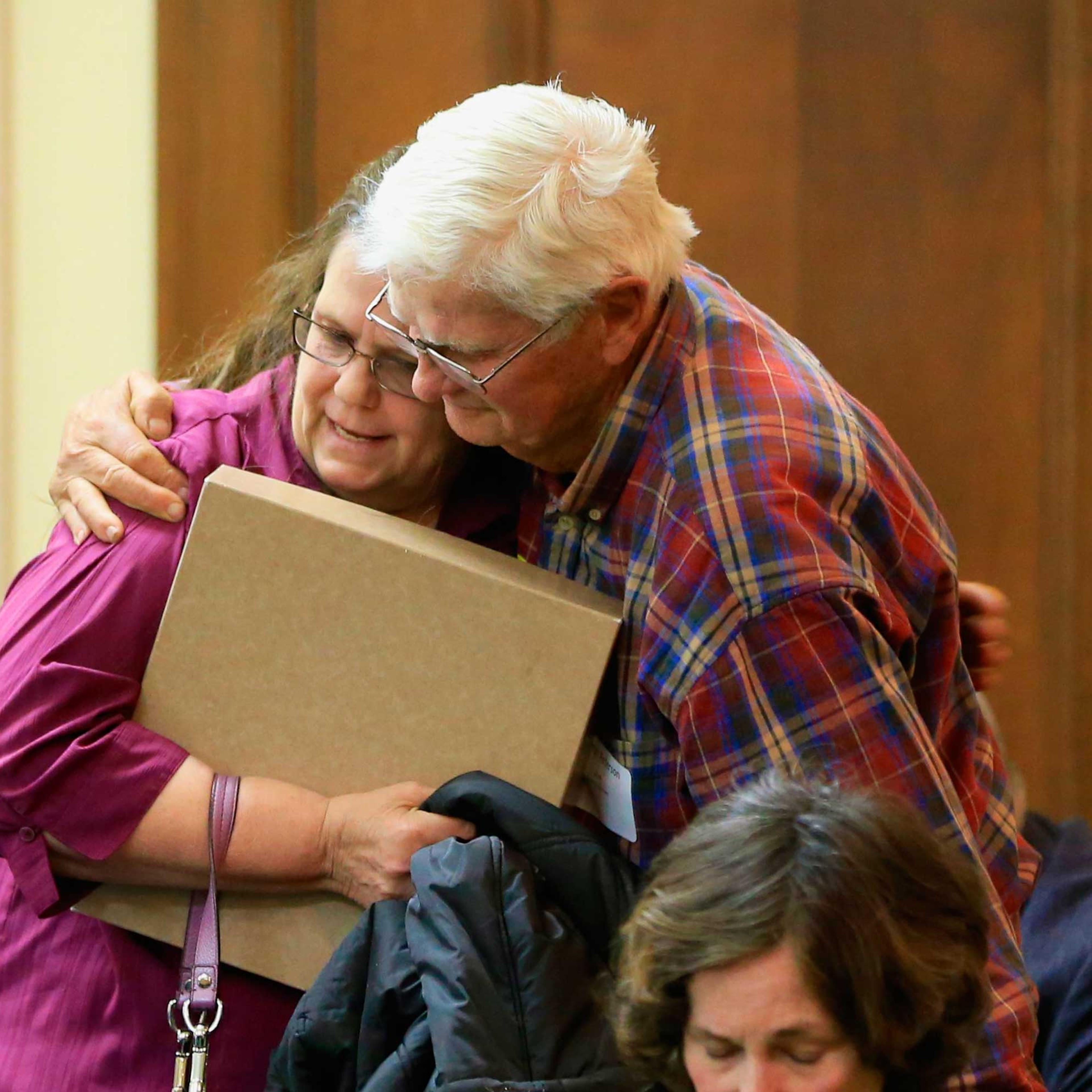 Miriam Thimm Kelle, left, whose brother James Thimm was tortured and killed on a southeast Nebraska farm in 1985, is hugged by Byron Peterson of Scottsbluff, after she testified in favor of a law proposal to change the death penalty to life imprisonment