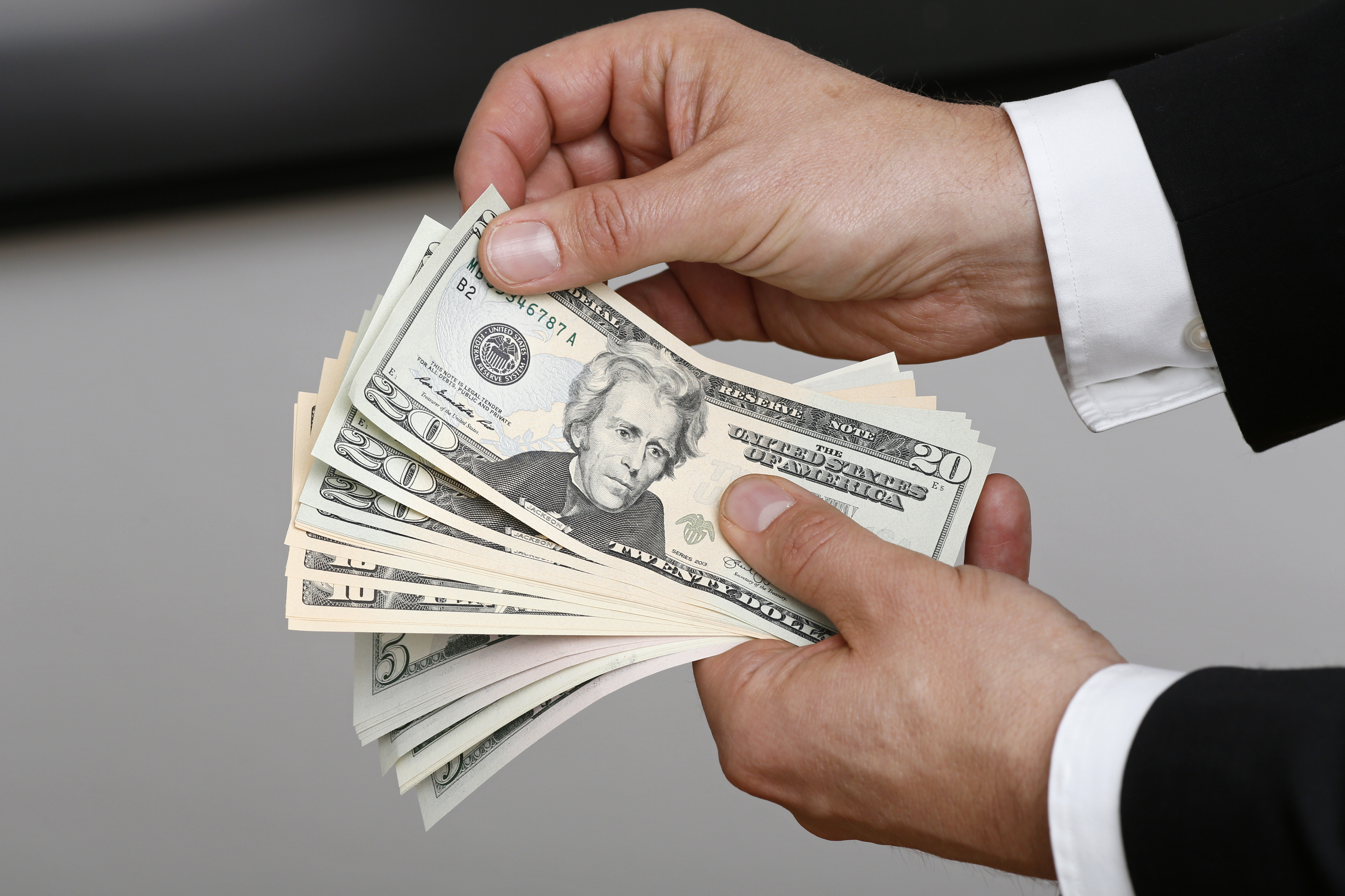 Businessman Holding US Dollars