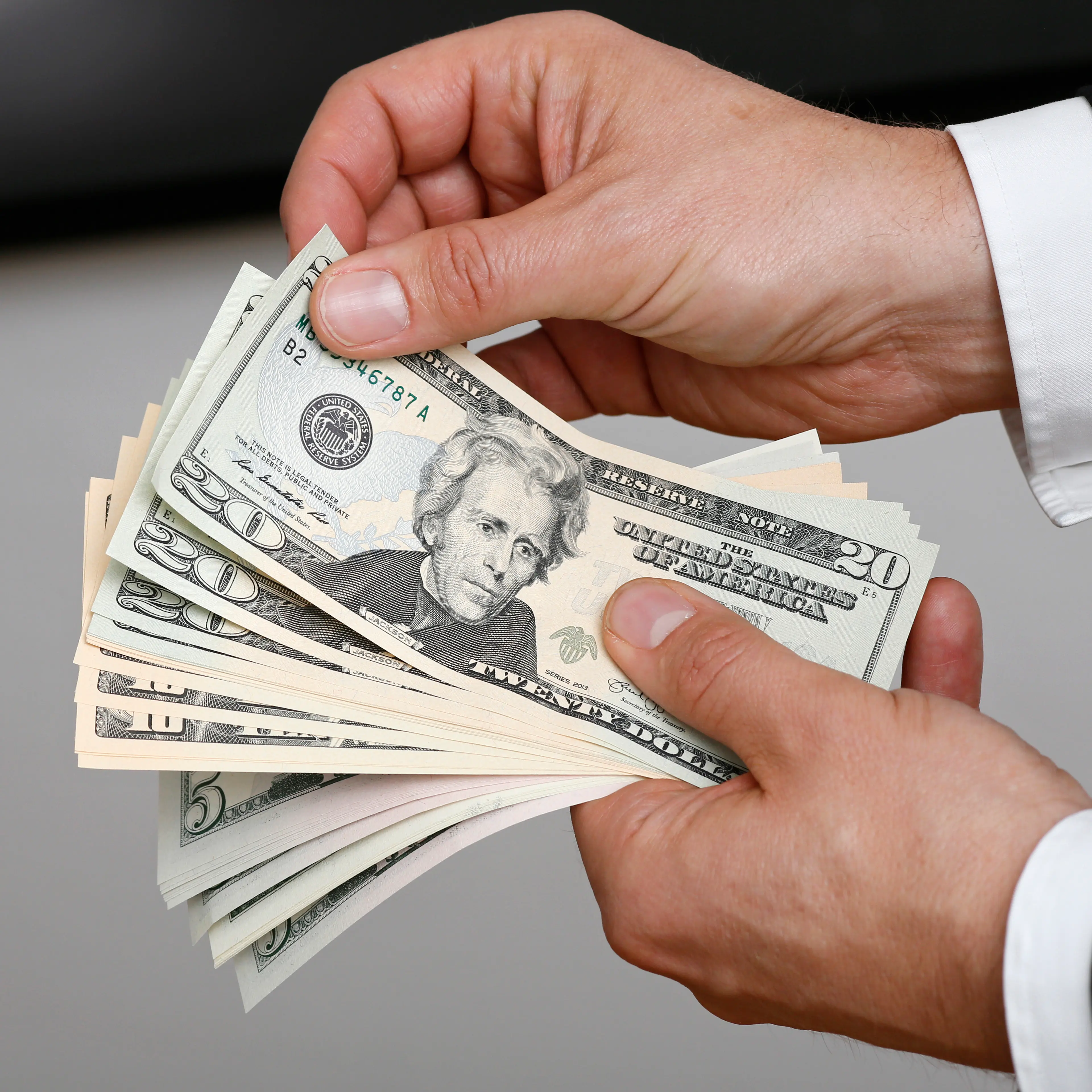 Businessman Holding US Dollars