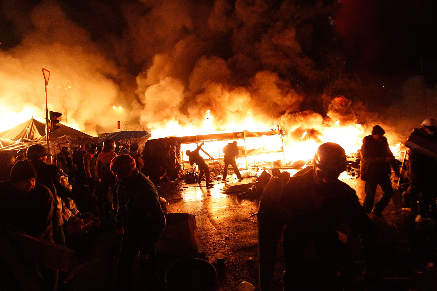 Anti-government protesters throw missiles during clashes with riot police at the Independence Square in Kiev