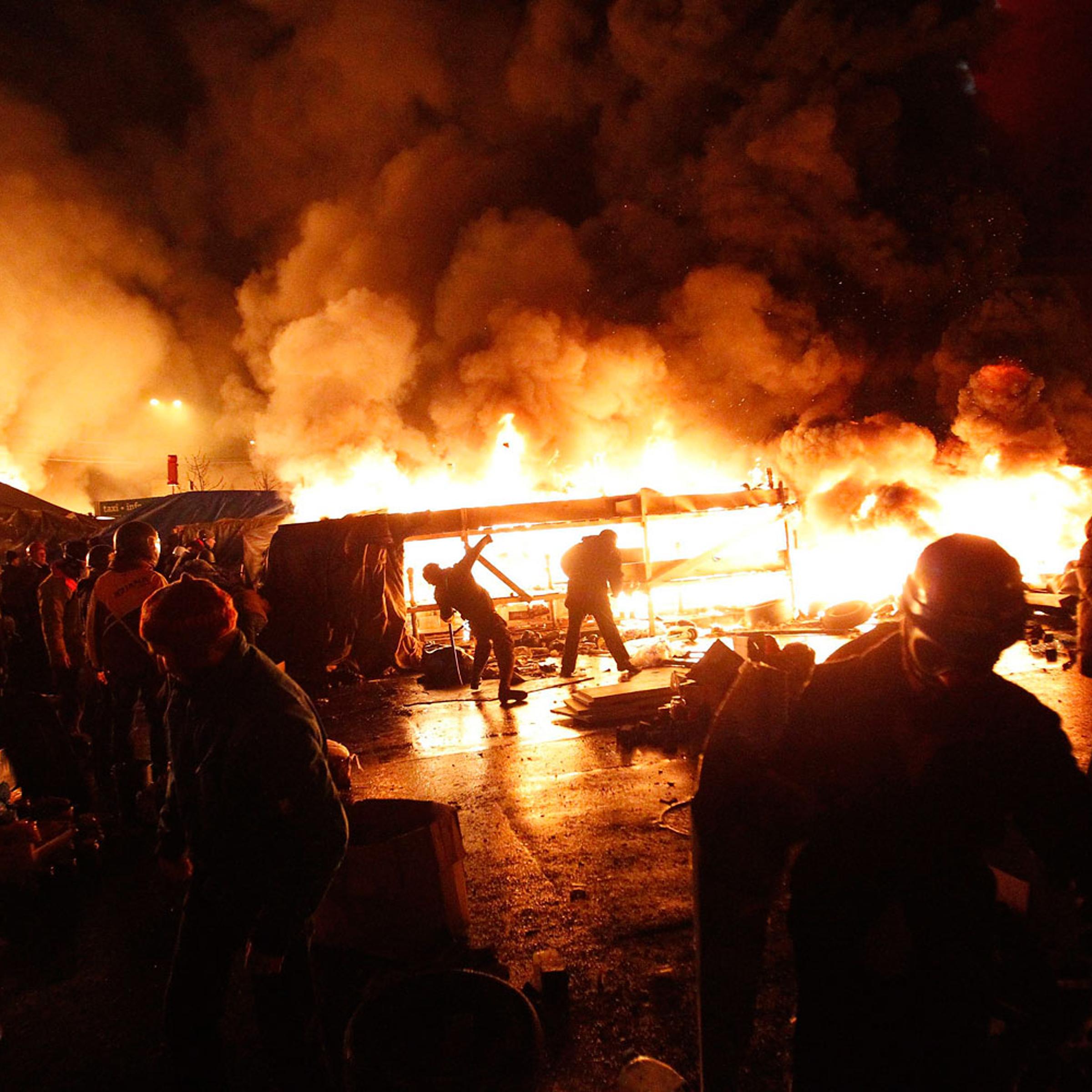 Anti-government protesters throw missiles during clashes with riot police at the Independence Square in Kiev