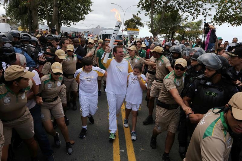 Mayor Eduardo Paes carries the Olympic torch in Rio de Janeiro