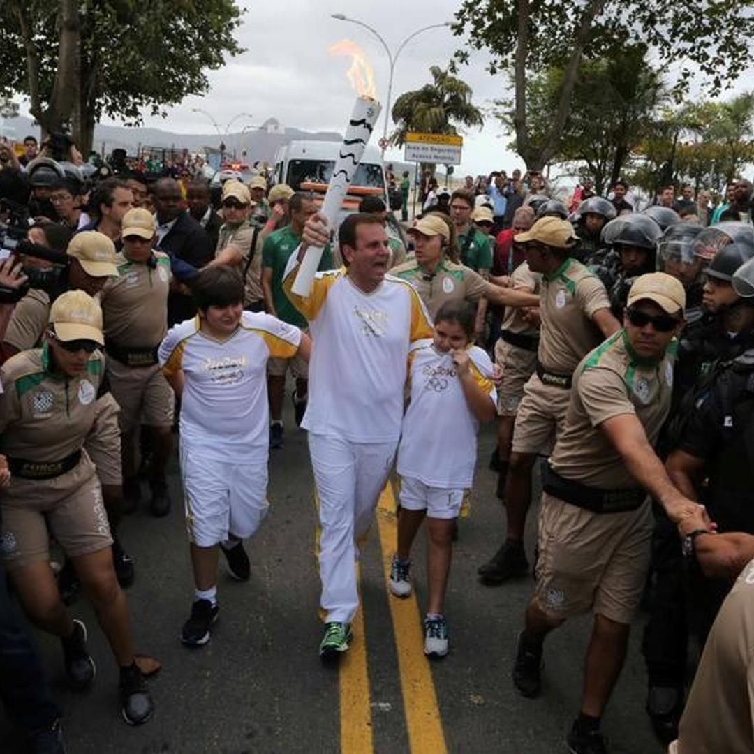 Mayor Eduardo Paes carries the Olympic torch in Rio de Janeiro