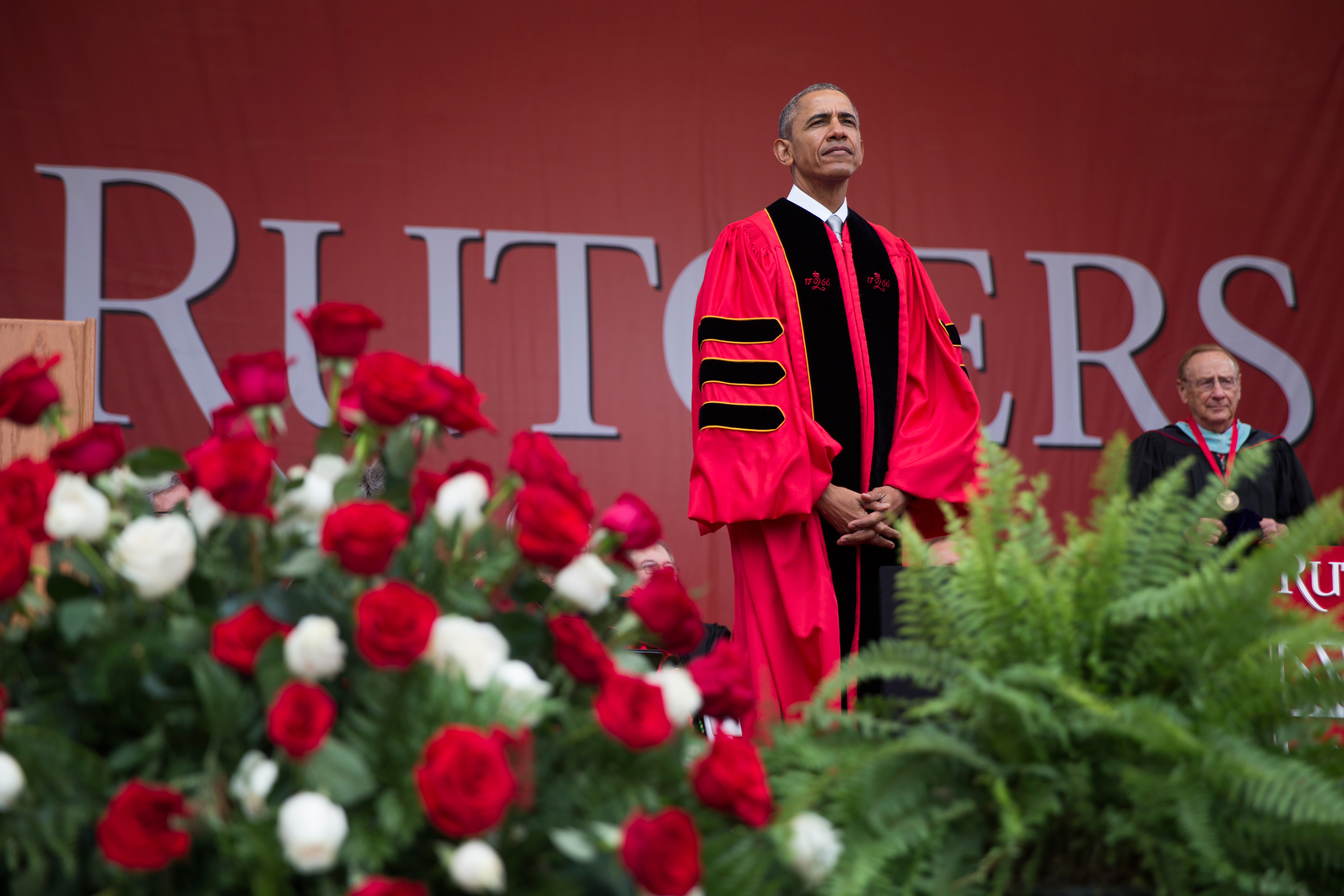 President Barack Obama listens during Rutgers University's 250th Anniversary commencement ceremony, on Sunday, May 15, 2016, in Piscataway, N.J. (AP Photo/Evan Vucci)