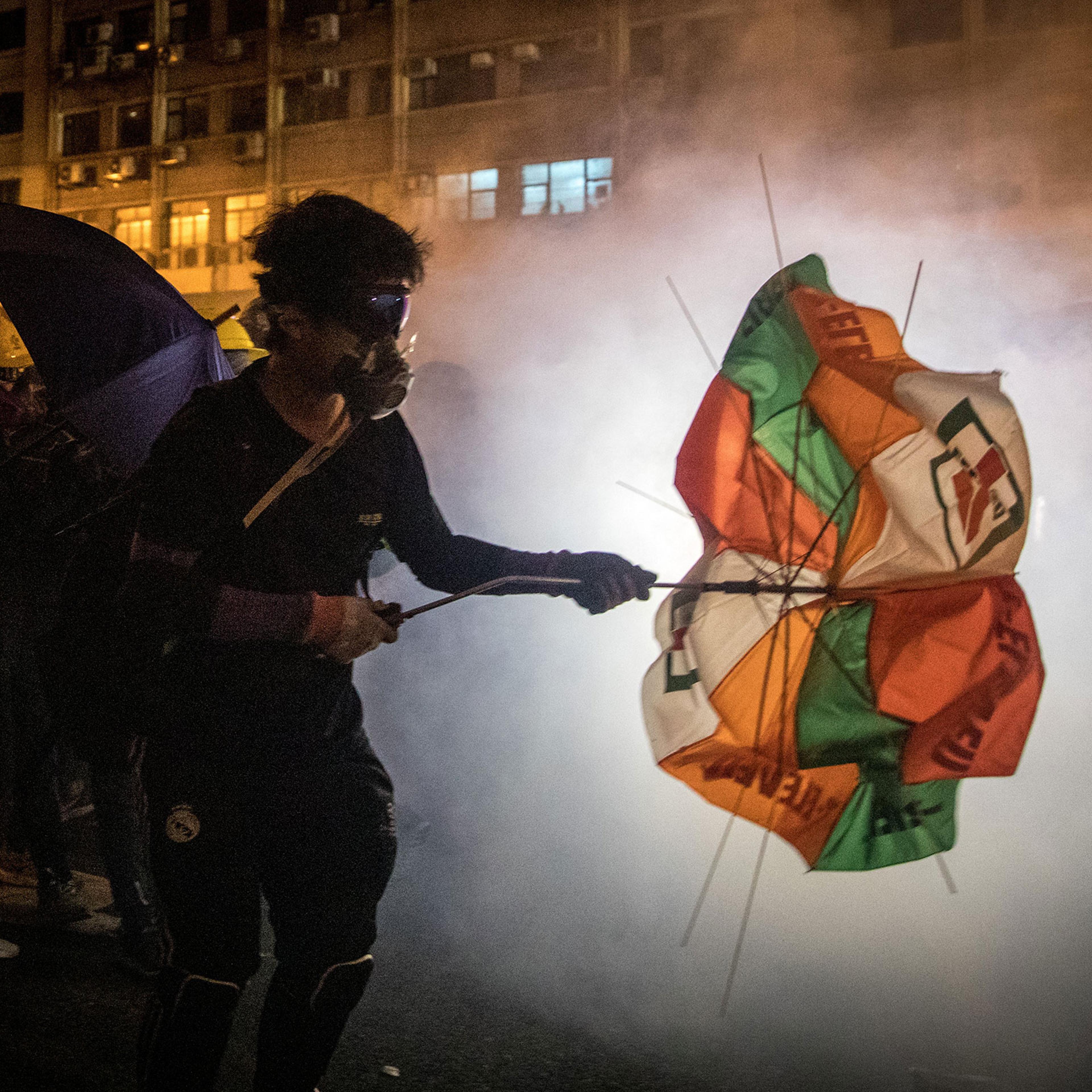 Protesters clash with police amid tear gas after taking part in an anti-extradition bill march on July 21 in Hong Kong.