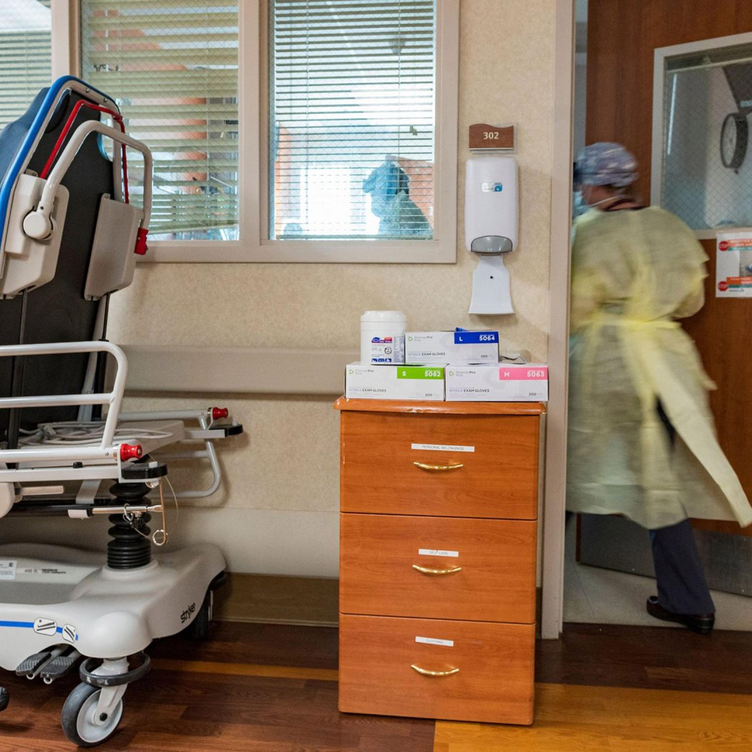 A nurse enters a Covid-19 patient's room inside the ICU at Adventist Health in Sonora, Calif., on Aug. 27, 2021.