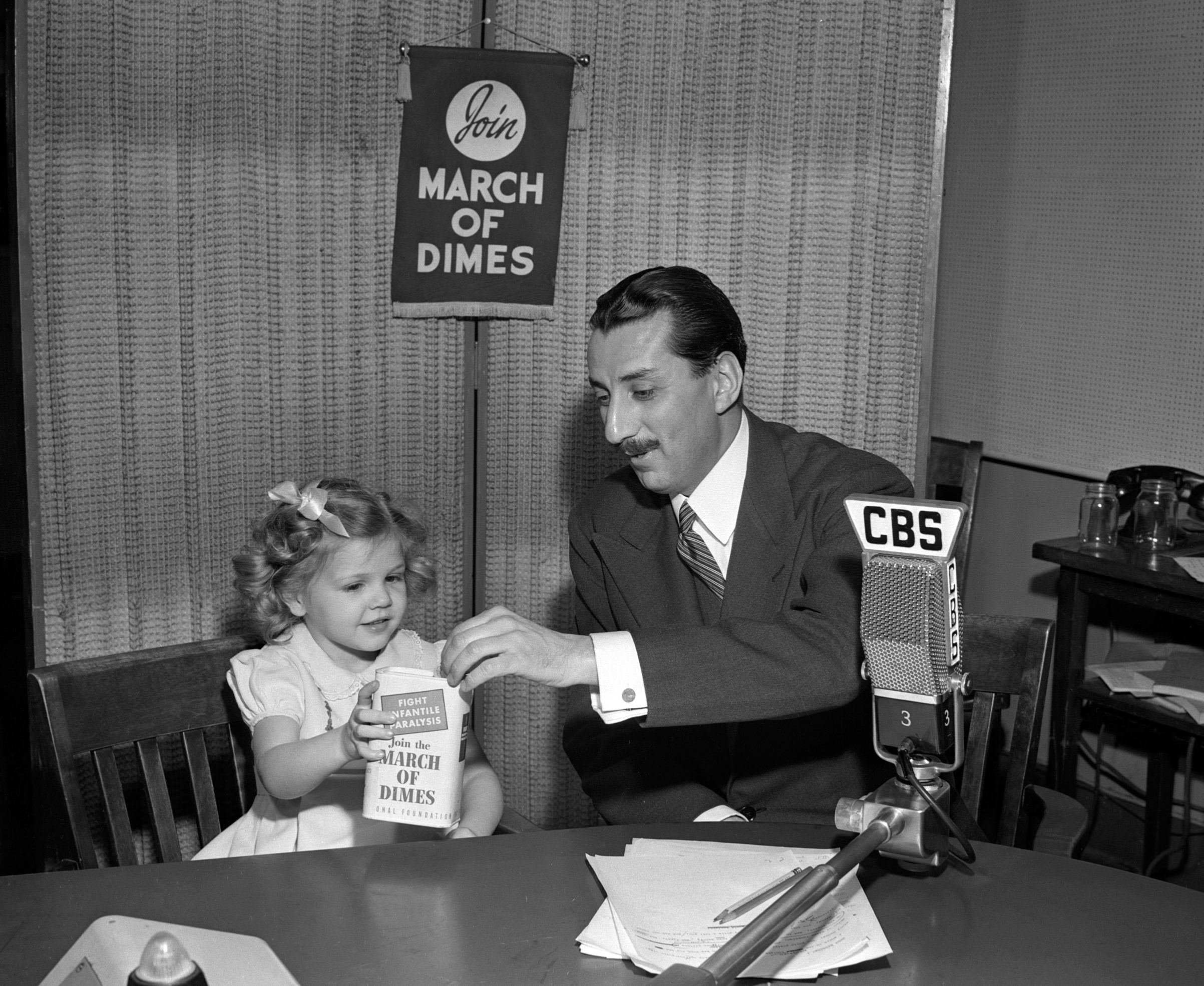 CBS Newsman Robert Trout with Nancy Drury, polio survivor and poster child for the March of Dimes on January 15, 1947.