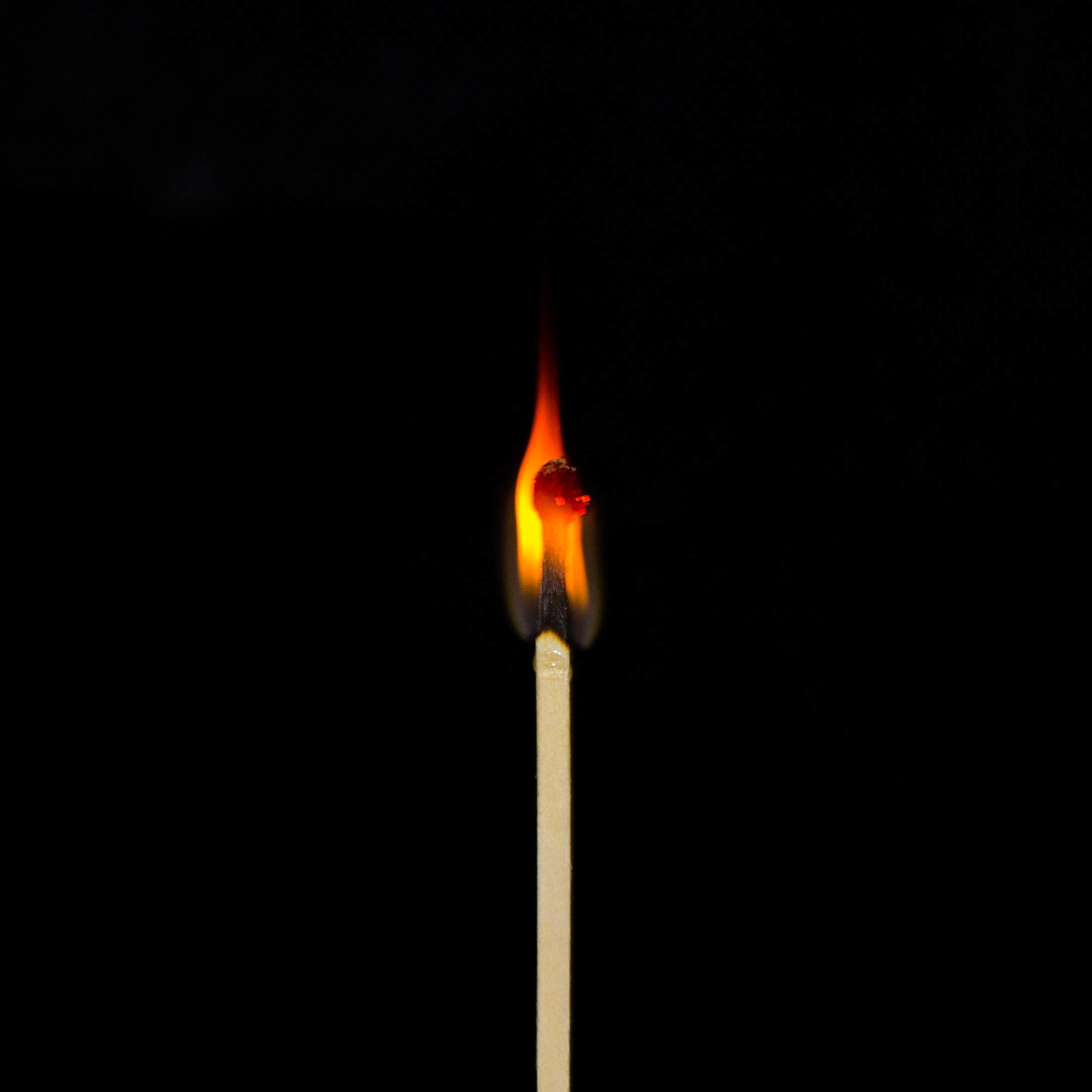 Close-Up Of Burning Matchstick Against Black Background