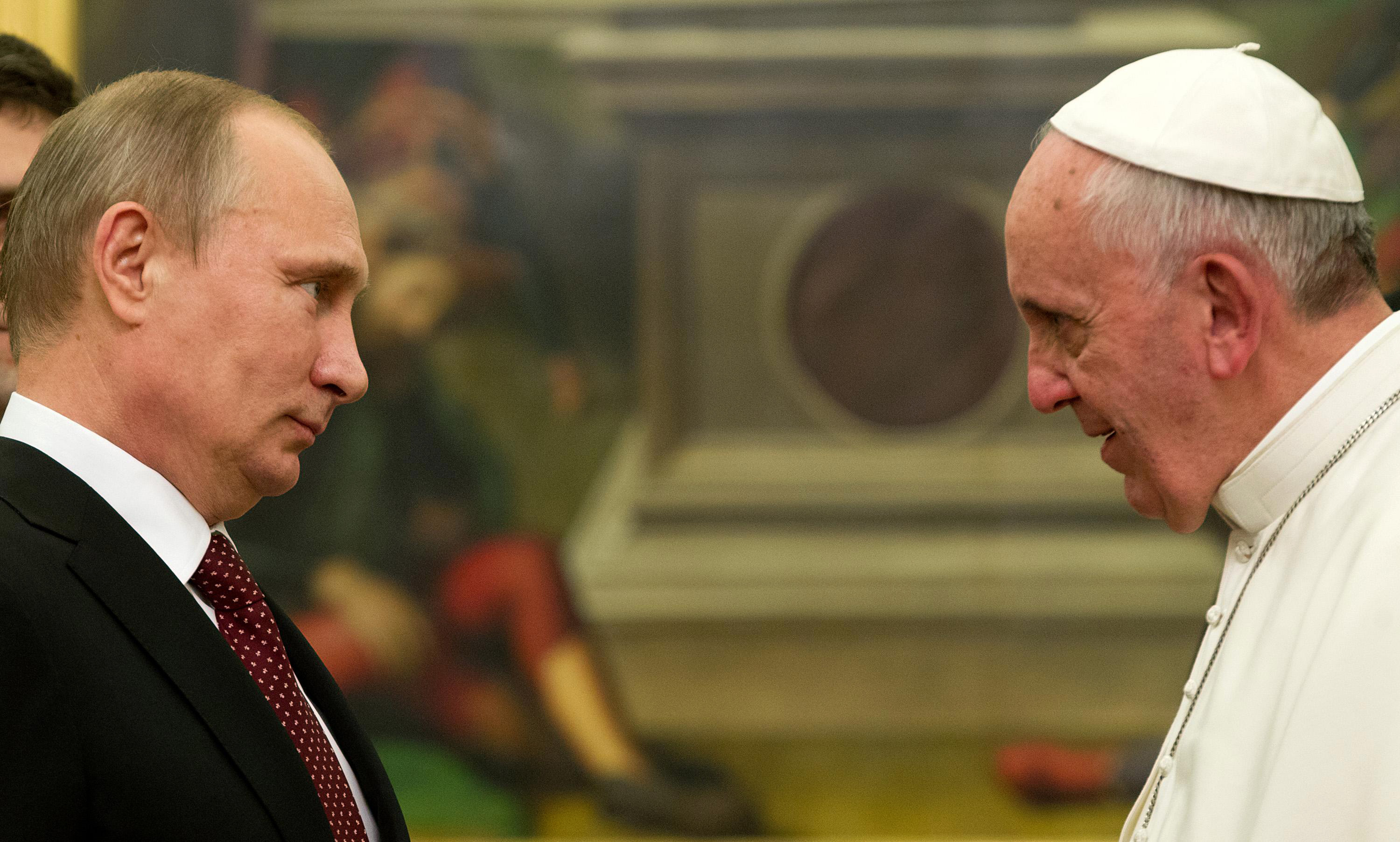 Pope Francis speaks to Russian President Vladimir Putin, left, on the occasion of their private audience at the Vatican on Nov. 25, 2013.