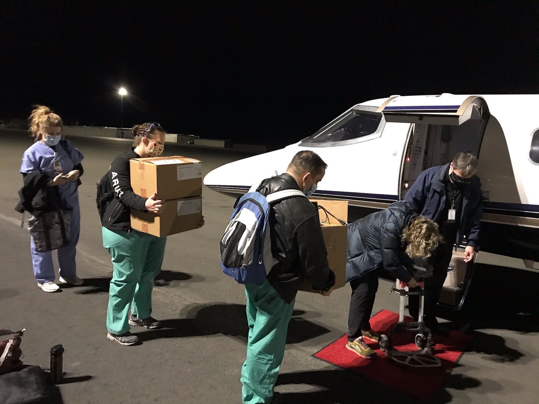 A vaccination team bound for Havre, Montana, loads supplies for the Moderna mRNA-1273 vaccine into a Learjet 31 at Helena Regional Airport. Also on board were six Veterans Affairs providers tasked with inoculating rural veterans with the covid-19 vaccine