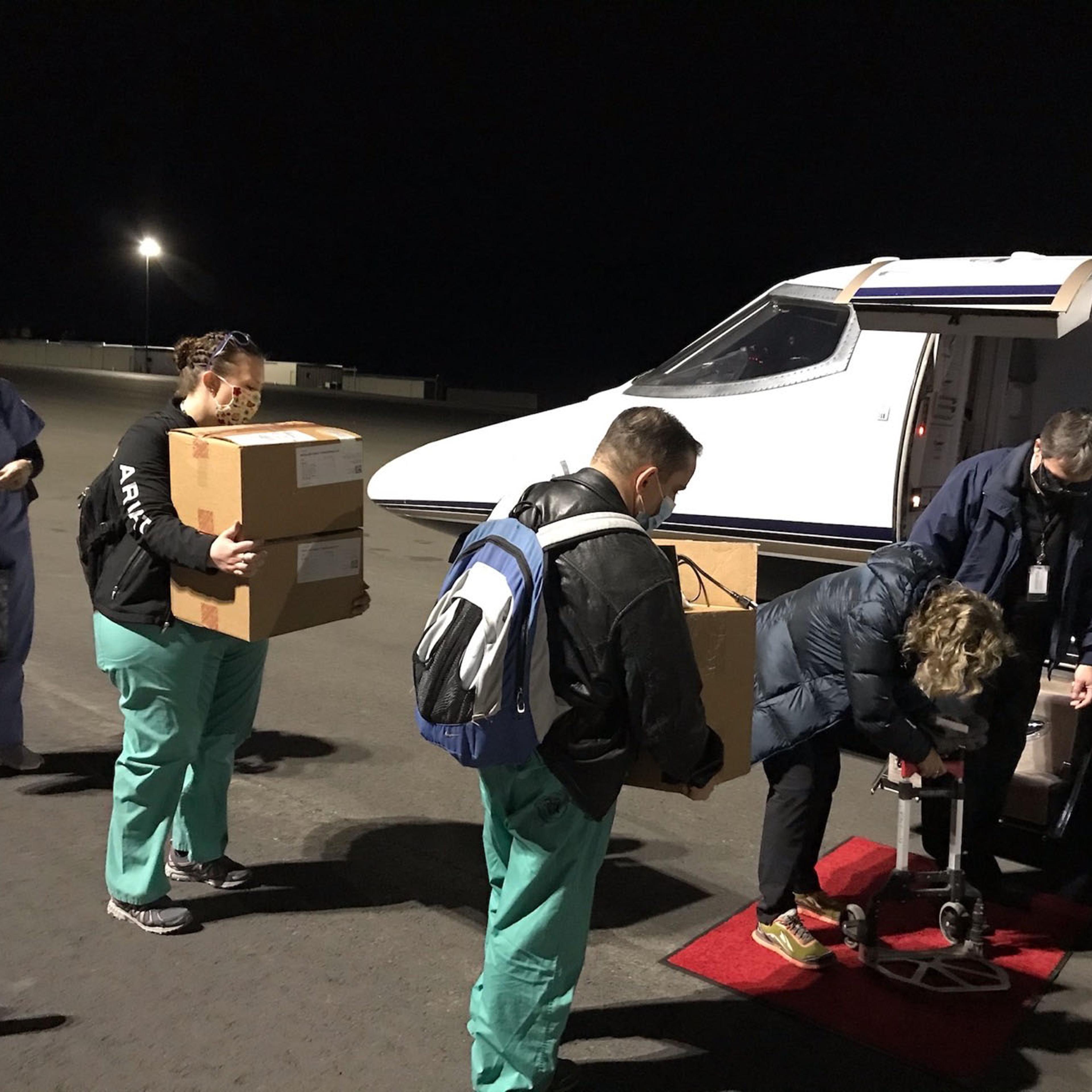 A vaccination team bound for Havre, Montana, loads supplies for the Moderna mRNA-1273 vaccine into a Learjet 31 at Helena Regional Airport. Also on board were six Veterans Affairs providers tasked with inoculating rural veterans with the covid-19 vaccine