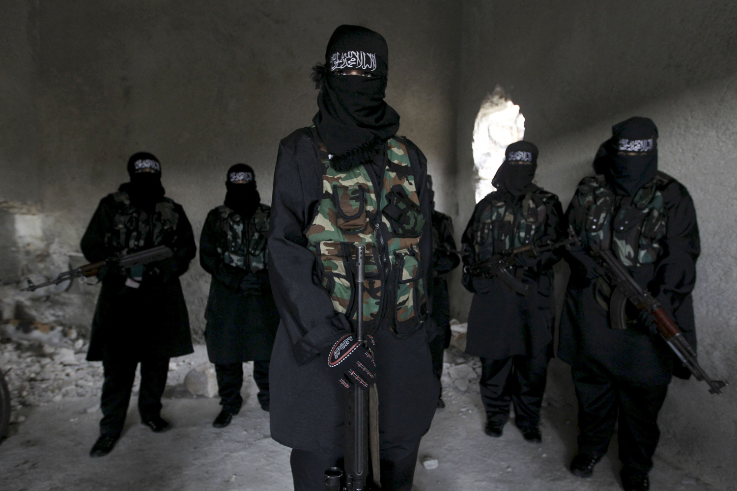 Women, who are part of the Sawt al-Haq (Voice of Rights), stand with their weapons as they undergo military training in Aleppo