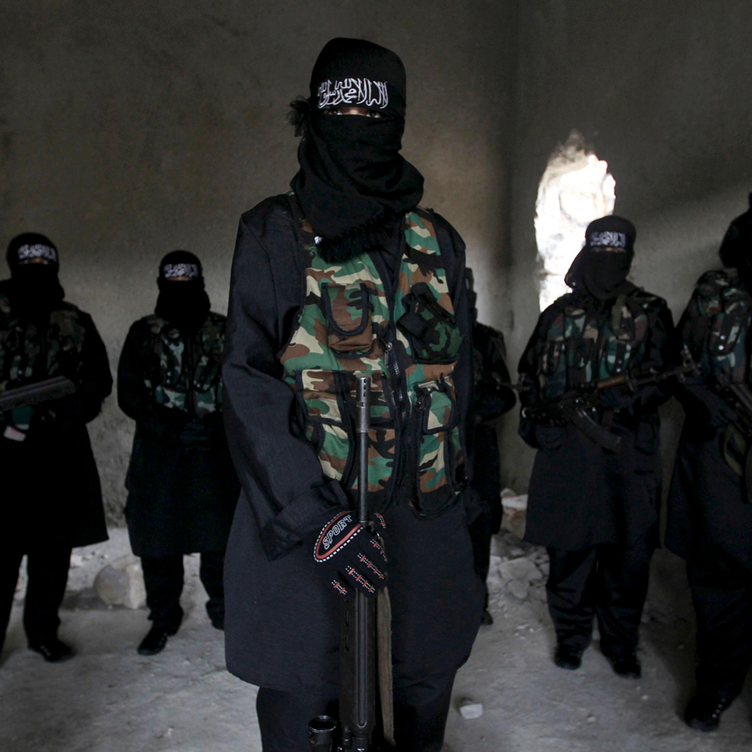 Women, who are part of the Sawt al-Haq (Voice of Rights), stand with their weapons as they undergo military training in Aleppo