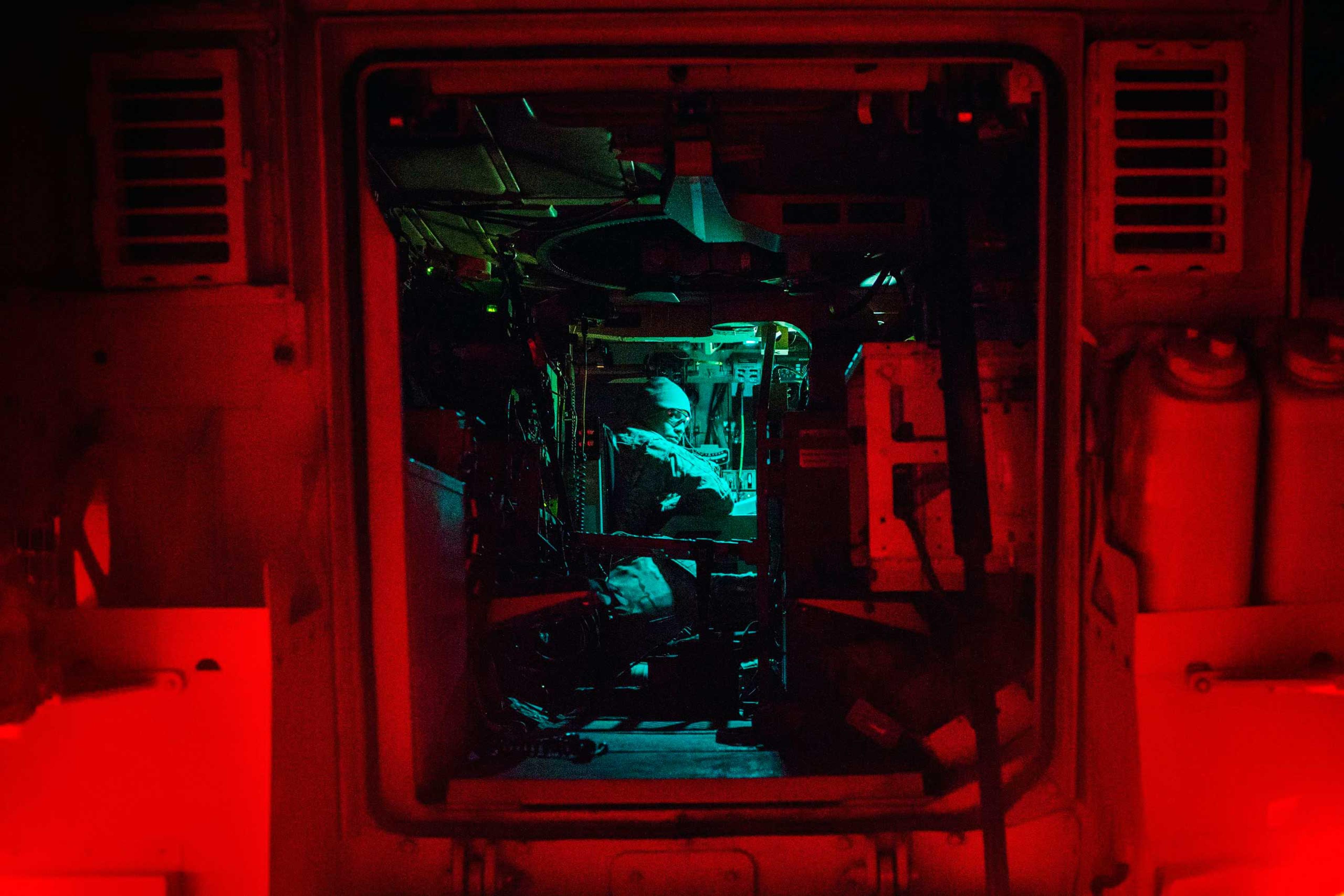 A U.S. soldier from Grim Company of the 3rd Cavalry Regiment sits in an MRAP vehicle as he prepares for an early morning mission at Forward Operating Base Fenty in the Nangarhar province of Afghanistan