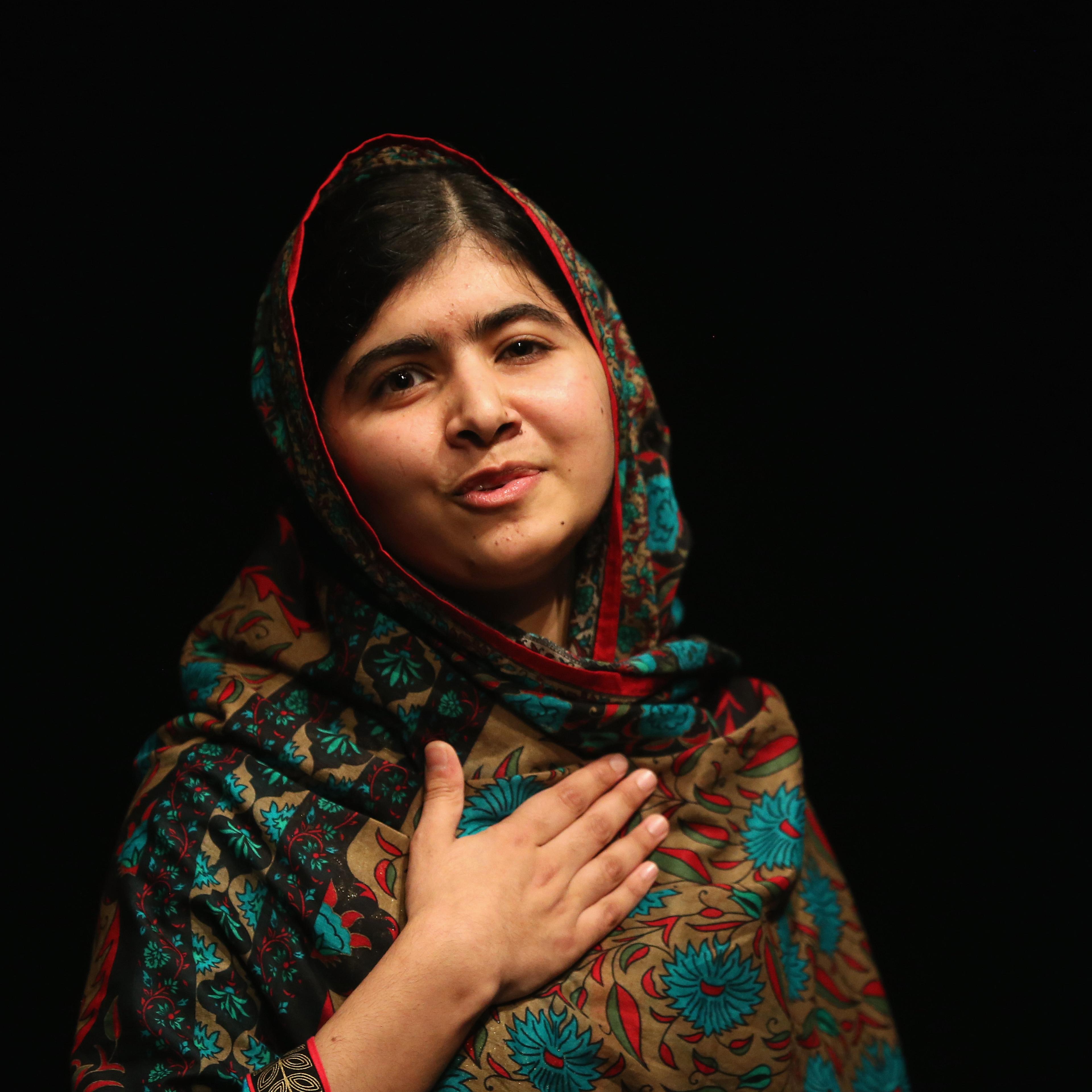 Malala Yousafzai acknowledges the crowd at a press conference at the Library of Birmingham after being announced as a recipient of the Nobel Peace Prize on Friday.