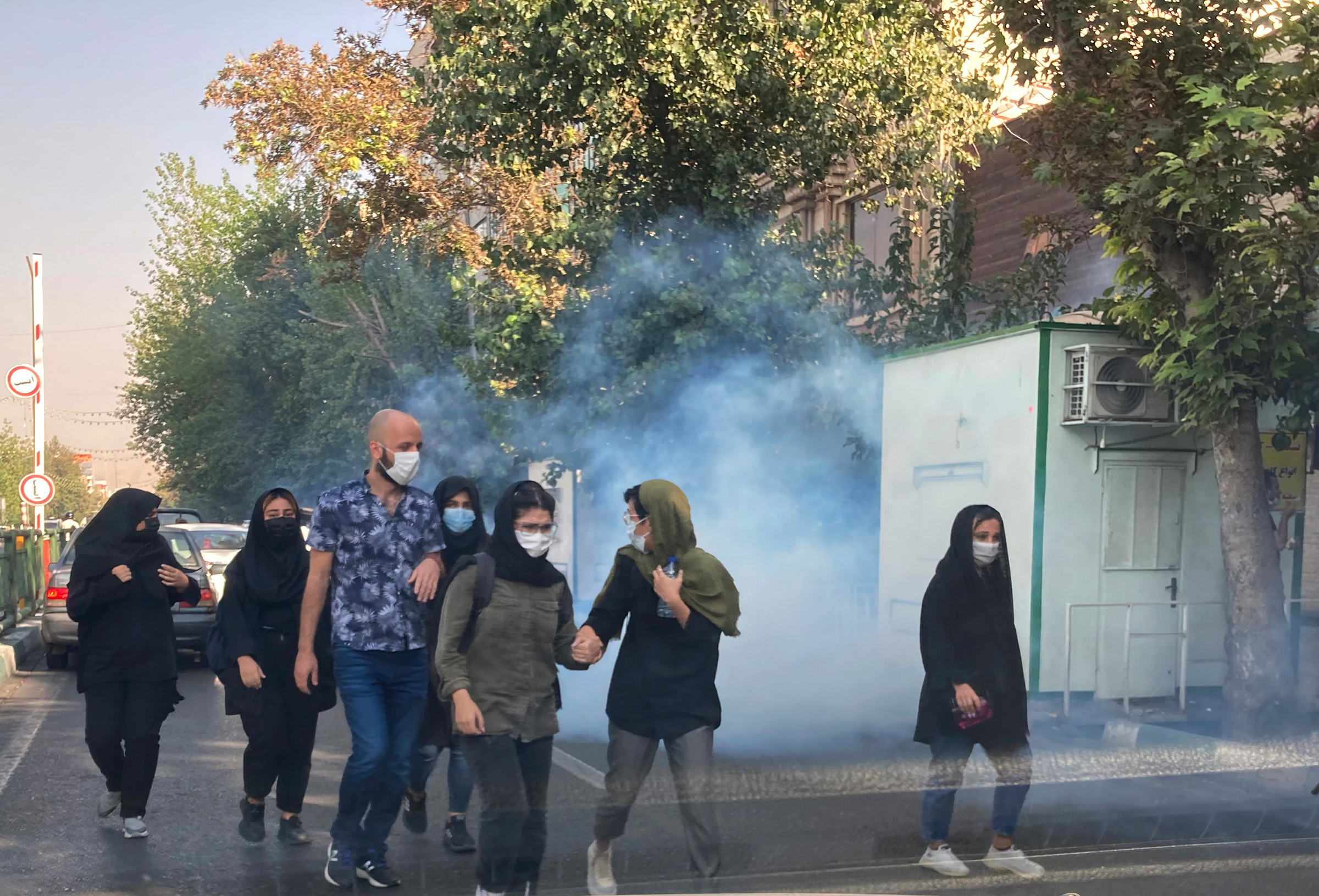 Tear gas is fired by security to disperse protestors in front of the Tehran University, Iran, on Oct. 1, 2022. 