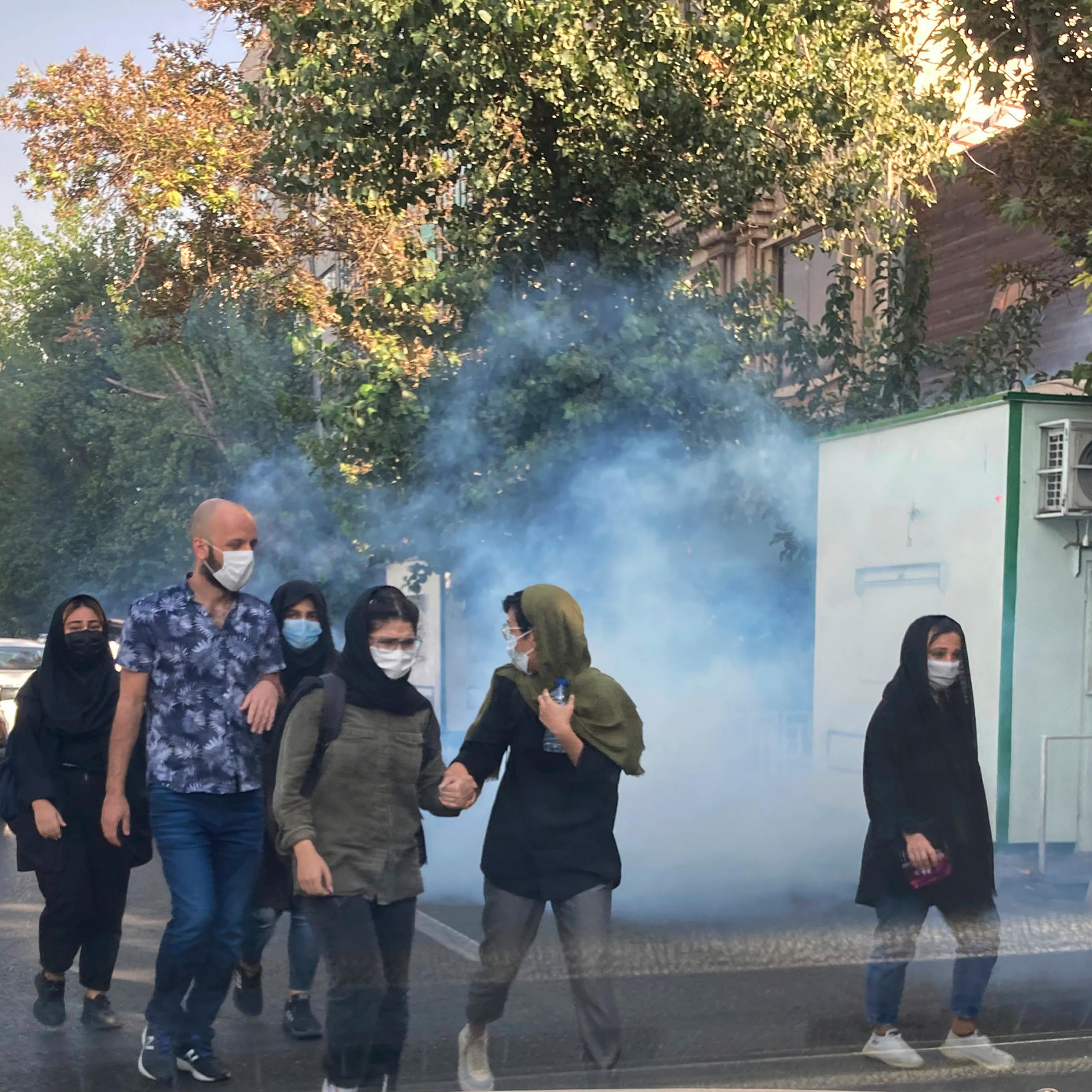 Tear gas is fired by security to disperse protestors in front of the Tehran University, Iran, on Oct. 1, 2022.