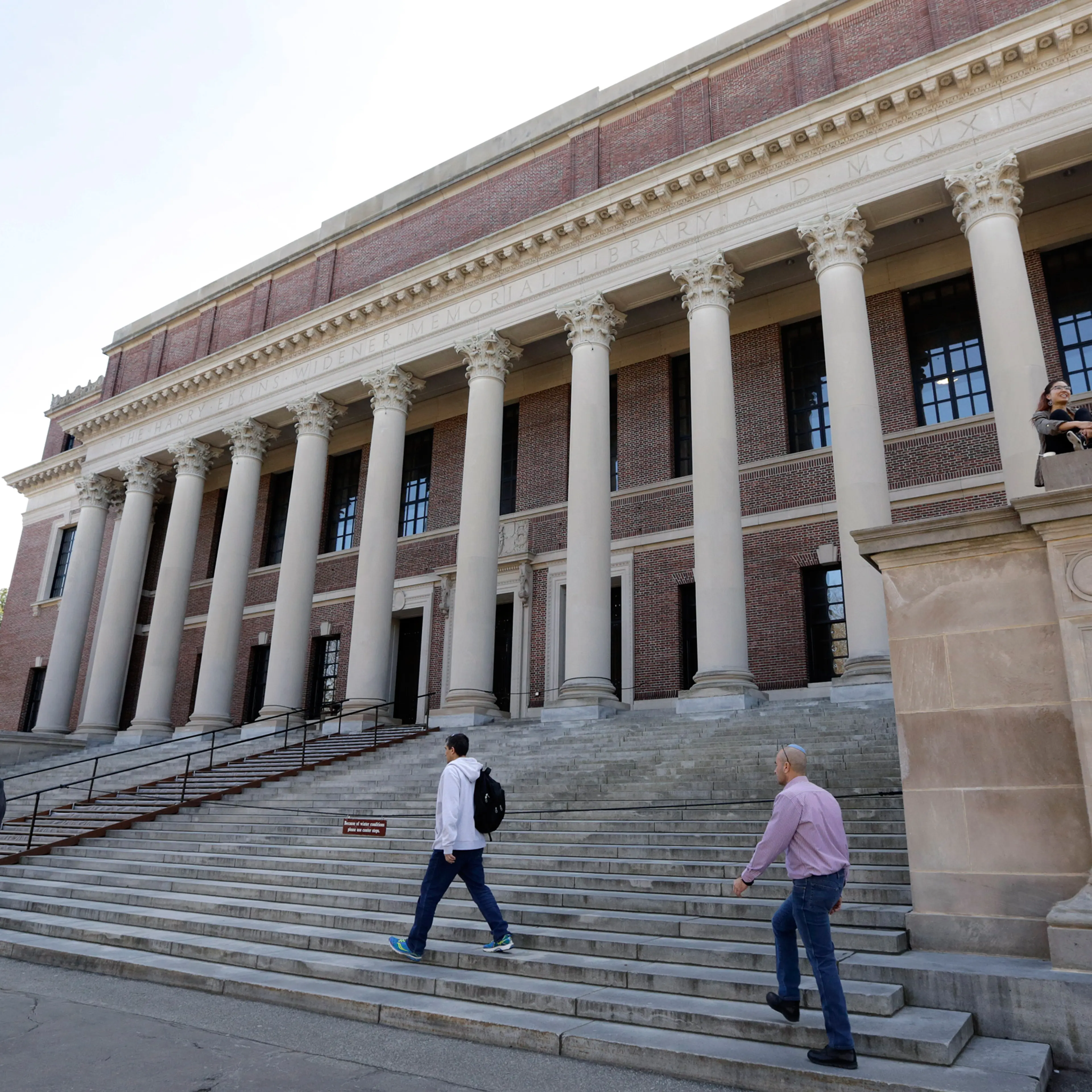In this Sunday, March 13, 2016 photo, people gather in front of Widener Library on the campus of Harvard University, in Cambridge, Mass. (AP Photo/Steven Senne)