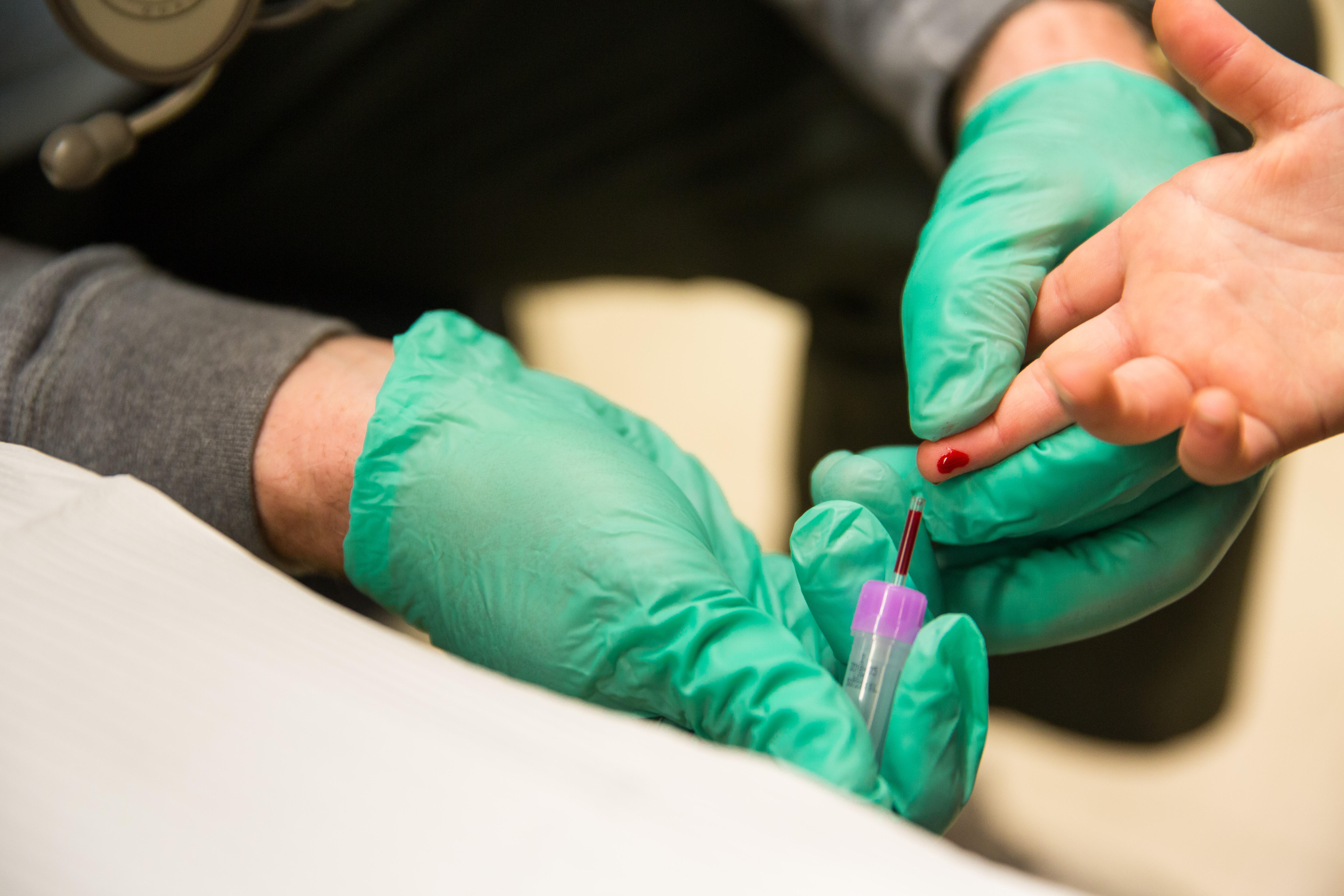 A first responder draws the blood of a five-year-old girl to screen her for lead at Eisenhower Elementary School in Flint, Mich., Jan. 26, 2016.