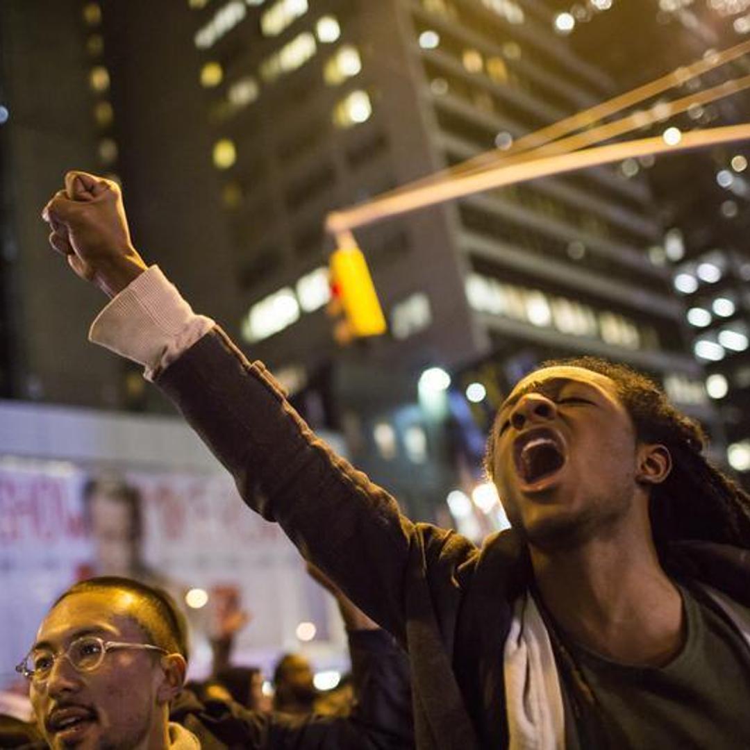 People take part in a protest against the grand jury decision on the death of Eric Garner in midtown Manhattan in New York