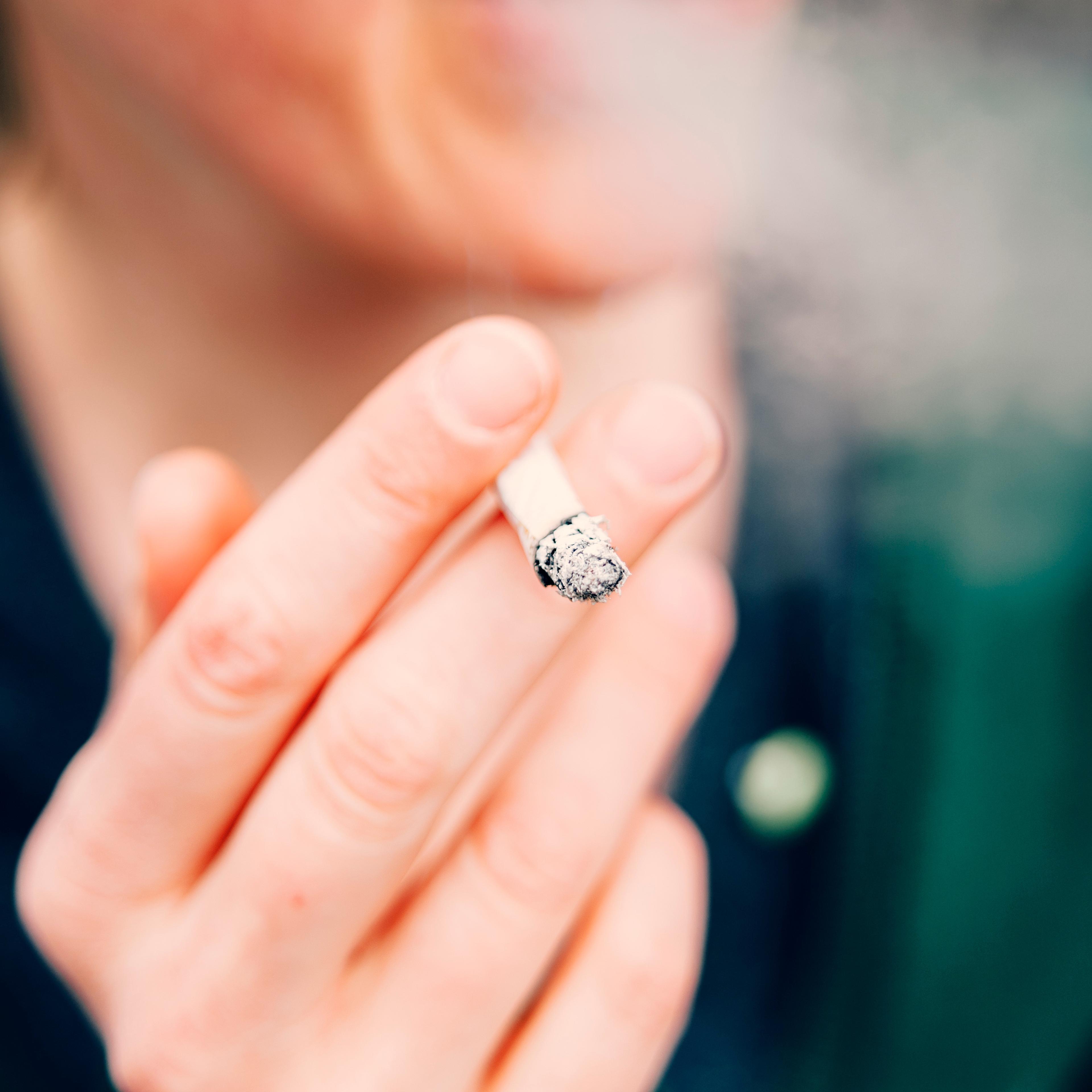 Cropped Hand Of Woman Holding Cigarette